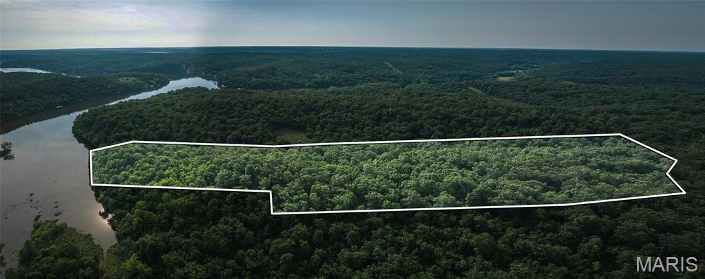 Introducing 25.5 +/- wooded acres with valuable lake frontage on Lake of the Ozarks, offering a rare combination of privacy, recreation, and build potential. Mature hardwood timber stretches across rolling terrain, creating multiple secluded homesite options with scenic views tucked beneath the canopy.

Enjoy fishing, kayaking, and quiet shoreline access right from your own property. Natural draws, thickets, and edge cover support strong movement of deer and turkey, making this acreage an excellent choice for hunters and wildlife enthusiasts. Trails could easily be added for improved access, ATV/UTV riding, or hiking.

Whether you’re planning a private retreat, weekend cabin, or future investment, this tract checks the boxes for lake proximity, natural beauty, and year-round recreation. Convenient to boat ramps, marinas, waterfront dining, and local amenities—yet peaceful enough to feel truly removed.

Acreage with lake frontage at the Lake of the Ozarks continues to grow in demand and become increasingly harder to find. Build, relax, or simply hold as a long-term asset—you won’t want to miss this opportunity.

Agent/Owner
