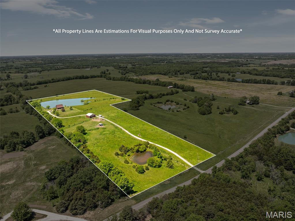 Discover your own slice of paradise with this exceptional 20-acre horse ranch, perfectly situated for both privacy and convenience. This property features a well-built 4-bedroom, 3-bathroom residence designed for comfort and style built in 2004. The home features cedar siding and a new shingled roof. From your new home, you can enjoy the serene views from the full covered front and back porches, perfect for relaxation and entertaining. A stunning 3.2-acre lake offers a tranquil setting for fishing, kayaking, or simply enjoying nature. While the 40 x 40 horse barn provides ample space for your equine companions, ensuring they're well-cared for and sheltered. The entire property is securely fenced, making it ideal for horses and other livestock. Enjoy the peace and tranquility of rural living while being conveniently located on a hard surface road, just minutes from town. This property is a rare find for anyone seeking an idyllic lifestyle surrounded by nature. Don't miss your chance to own this incredible horse ranch in Missouri! Book your showing today!