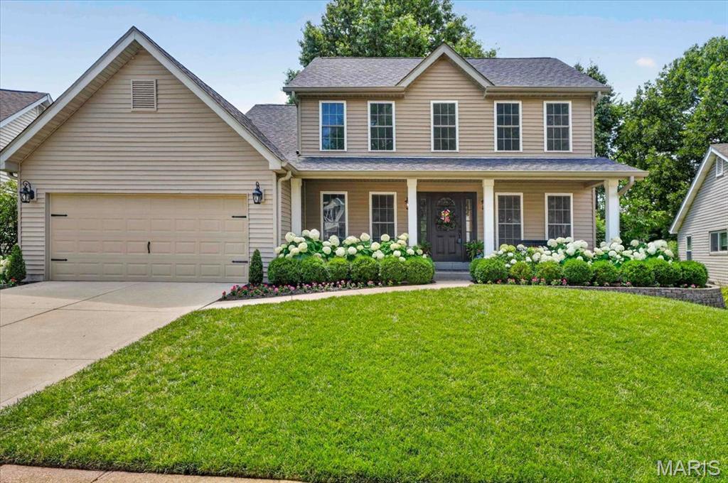 Tucked away on a quiet cul-de-sac and backing to a peaceful tree-lined setting, this impeccably maintained two-story home reflects years of exceptional care and attention to detail. The beautifully landscaped level lot offers multiple outdoor living spaces, including paver patios and a covered patio, creating the perfect backdrop for relaxing evenings or entertaining family and friends. Inside, rich wood flooring flows throughout the main living areas, setting a warm and welcoming tone. The family room serves as the heart of the home, featuring a wood-burning fireplace and built-in cabinetry. A separate dining room provides an elegant space for gatherings, while the recently updated and thoughtfully designed kitchen combines style and function with new quartz countertops, a center island, stainless steel appliances, an electric cooktop, a pantry, and an adjoining breakfast room highlighted by a bay window and direct access to the outdoor living areas. The 1st floor is finished with crown molding, custom millwork and baseboards. Upstairs, brand new carpeting enhances the entire upper level, including the vaulted primary suite, which offers a private retreat with a spacious walk-in closet and beautifully updated bath featuring granite-topped double vanities and an oversized walk-in shower. Three additional bedrooms and a full bath complete the upper level. The finished lower level expands the living space with a comfortable family room perfect for movies or gaming, complete with a dry bar with a quartz countertop, dimmable, zoned lighting, and abundant storage space. Additional highlights include a main-floor laundry room, two-car garage, newer windows, vinyl siding, & gutters and newer HVAC. Residents enjoy access to outstanding neighborhood amenities, including two pools, tennis courts, and a sports court. Meticulously cared for and thoughtfully updated throughout, this is a home where pride of ownership is evident at every turn, offering a rare combination of comfort, quality, and an exceptional setting.