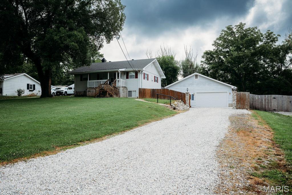 This home has many updates.  Large half acre lot with large 34x27 detached garage that includes heat and AC along with a bathroom rough in. If your hobby is working on cars, motorcycles or trucks, this is for you! A covered front porch with vinyl siding and enclosed soffits. You won't believe the inside. White six panel doors, new main floor laminate flooring, fresh paint, eat-in kitchen with a large center island and plenty of cabinet space. All kitchen appliances and the washer and dryer stay with the house!  Sliding door going out to the 15X16 sundeck. Roof is approximately 5 years old. Walk out basement with 18x10 sleeping room. Plenty of storage available in the house, the detached garage and the shed in the backyard.