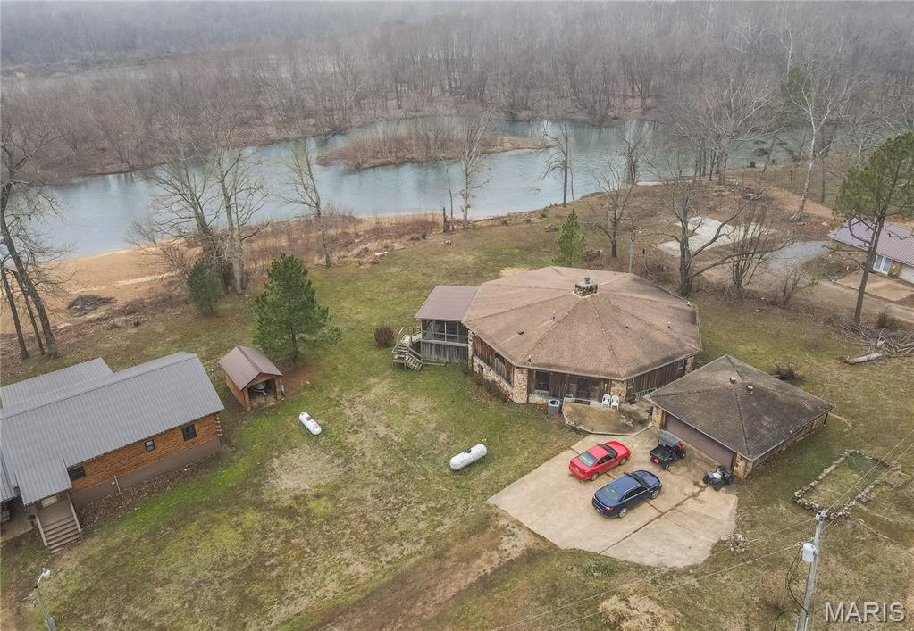 Set on 1.1 scenic acres, this spectacular riverfront retreat offers breathtaking water views and direct access to outdoor adventure. Featuring 3 spacious bedrooms and 3.5 baths, the thoughtfully designed layout includes three dedicated sleep lofts - ideal for hosting guests or perfect for an Air B-n-B. Expansive windows frame the river, filling the home with natural light and capturing the serene setting.  Enjoy convenient gravel bar (steps go down from property) and boat launch access, making it easy to spend your days on the water. A 2-car detached garage provides ample storage for vehicles and recreational gear. Whether you're seeking a full-time residence or a private getaway, this property blends comfort, space, and natural beauty in an unforgettable setting.