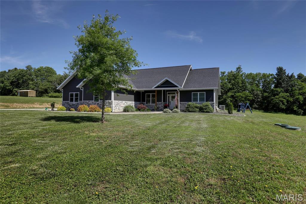 Built in 2021, this beautiful 3-bedroom, 2-bath home offers the perfect combination of modern comfort and country living. Situated on approximately 4 acres, the property provides plenty of space to enjoy the outdoors while remaining just minutes from town.

Inside, you'll find 1,700 square feet of thoughtfully designed living space featuring an open-concept living room, dining area, and kitchen—ideal for everyday living and entertaining. The spacious primary suite includes a large walk-in closet and a private bath complete with both a relaxing soaking tub and a separate walk-in shower for added convenience.

The 25 x 25 attached 2-car garage offers ample room for vehicles, storage, and even a dedicated workspace for hobbies or projects. Outside, the open and highly usable acreage creates endless possibilities, whether you're interested in gardening, outdoor recreation, pets, or simply enjoying the peace and privacy of your own land.

If you've been searching for a newer home with acreage, functional living space, and room to make your own, 56900 Patriot Lane, New London, MO is a property you won't want to miss. Schedule your showing today!