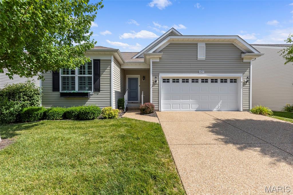 Welcome to carefree living in Heritage of Hawk Ridge! This beautifully maintained 2016 2-bedroom, 2-bath ranch offers the comfort, convenience, and active lifestyle you've been looking for in one of Lake St. Louis' premier 55+ communities. Step inside to an inviting open floor plan featuring beautiful hardwood floors, plantation shutters throughout, and abundant natural light. The spacious kitchen is the heart of the home, boasting warm 42" maple cabinetry, a large center island, and a sunny breakfast area with access to the deck—perfect for enjoying your morning coffee while overlooking the lush backyard. The desirable split-bedroom floor plan provides privacy for both owners and guests. Both bedrooms feature brand-new carpet, while the generous primary suite offers a walk-in closet, double vanity plus a separate makeup vanity, and a private water closet. Additional highlights include main-floor laundry, a 2-car garage, and an unfinished walk-out lower level ready for storage, hobbies, or future finishing to fit your needs. Enjoy close proximity to upscale shopping at The Meadows, low-maintenance living and all the exceptional amenities Heritage of Hawk Ridge has to offer, including a clubhouse, fitness center, pools, walking trails. This is the perfect place to relax, connect, and enjoy the next chapter in style!