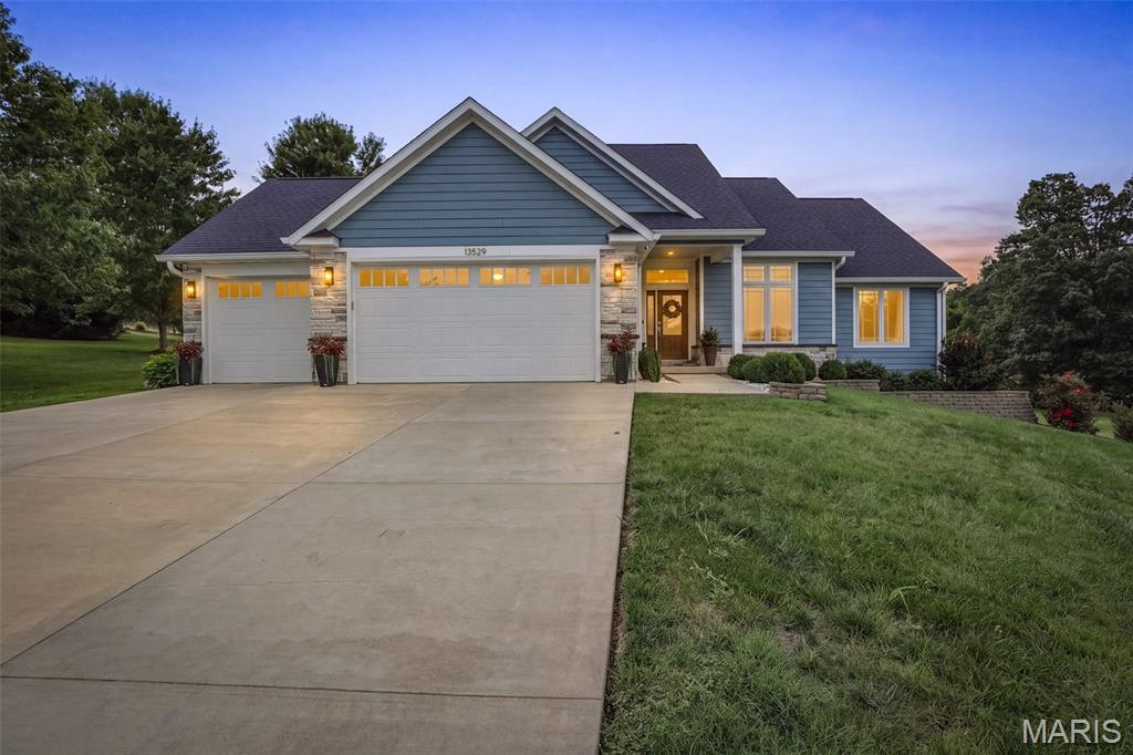 Built in 2018 and impeccably maintained, this stunning lakefront home offers the perfect blend of modern comfort, style, and recreation. Nestled on a private, beautifully landscaped lot with a lake-inlet along the perimeter, you'll love relaxing on the screened-in porch while enjoying peaceful views and the easy walk to the marina.

Step inside and be impressed by this beautifully designed 4-bedroom, 3-bath home offering approximately 2,900 square feet of finished living space with a warm mid-century modern vibe. The open-concept living and dining area features soaring vaulted ceilings, creating a bright and inviting space perfect for everyday living and entertaining.

The high-end kitchen is sure to impress with stainless steel KitchenAid appliances, solid surface countertops, abundant cabinetry, and a spacious breakfast bar that's ideal for gathering with family and friends. Just off the main living area, the expansive screened porch extends your living space outdoors, making it the perfect place to entertain or simply unwind.

The spacious primary suite offers a relaxing retreat with a large walk-in closet featuring custom built-in organizers and a luxurious ensuite bath complete with a walk-in shower. A convenient main-level laundry and mudroom with custom built-ins adds everyday functionality.

The finished walkout lower level has been thoughtfully designed for entertaining, featuring a custom wet bar with built-in entertainment center, high-top table, beautiful masonry stone fireplace, an additional bedroom, full bath, and plenty of storage. Step outside to the private backyard where you'll enjoy a spacious patio,  landscaping, and peaceful surroundings.

Additional features include a 3-car attached garage and exceptional curb appeal.

Beyond the home, enjoy all the amenities this sought-after lake community has to offer, including boating, water skiing, tubing on the main lake, outstanding fishing on all three lakes, an outdoor swimming pool, playground, marina, and common ground areas. Whether you're looking for a full-time residence or the ultimate weekend getaway, this exceptional property offers the lake lifestyle you've been dreaming of.

This is more than just a home—it's a lifestyle. Schedule your private showing today and experience everything this remarkable property has to offer.