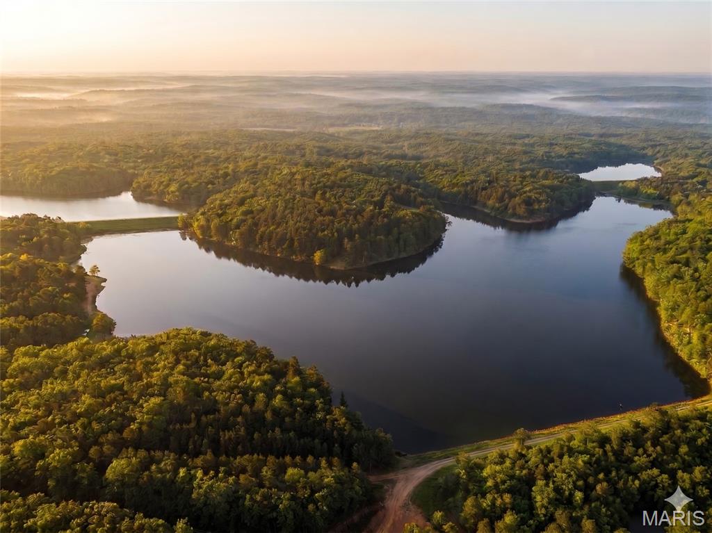51.89 Acres of "Summer Camp" Nostalgia: The Ultimate Wayne County Lake & Land Retreat
Escape the noise and rediscover the quiet at Turkey Creek Lakes. This surveyed 51.89-acre tract in Wayne County, MO, offers a rare, cinematic sense of seclusion that feels like a scene from a classic upstate summer camp movie. The journey to the property is an experience in itself—a scenic, winding drive through lush Missouri timber on a paved highway that signals you’ve  left the busy behind.
Tucked away in a deeply private setting, this acreage is defined by the hardwoods and the hushed atmosphere only a forest can provide. Despite its "middle-of-nowhere" feel, the property is remarkably prepared for your vision. A private well is already on-site and electricity is available, eliminating the biggest hurdles of rural development. The land is navigated by a network of quality internal roads, making every corner of your 51 acres accessible for recreation or choosing that perfect build site.
Ownership in this surveyed tract grants you exclusive access to the large private lakes maintained by the community association. These aren't just fishing ponds; one of the lakes is large enough to accommodate waterskiing and boating, providing a recreational outlet that is nearly impossible to find on private acreage. Whether you’re spent the morning in the woods or the afternoon behind a boat, this property offers a "best of both worlds" lifestyle that keeps every generation of the family engaged.
 While the setting feels worlds away, the logistics are effortless: you are approximately two hours from St. Louis and less than an hour from Poplar Bluff. Sensible restrictions are in place to ensure the quiet, high-end integrity of the community is preserved for generations to come.

?? Property & Community Highlights:
Surveyed Acreage: 51.89 +/- Acres 

Lake Access: Exclusive rights to large private community lakes (waterskiing permitted on the main lake).

Utilities: Private well and electricity already in place.

Access: Paved highway frontage with an established internal road system.

Location: 2 hours from St. Louis; <1 hour from Poplar Bluff.

The Vibe: Remote "summer camp" aesthetic with modern-day infrastructure.