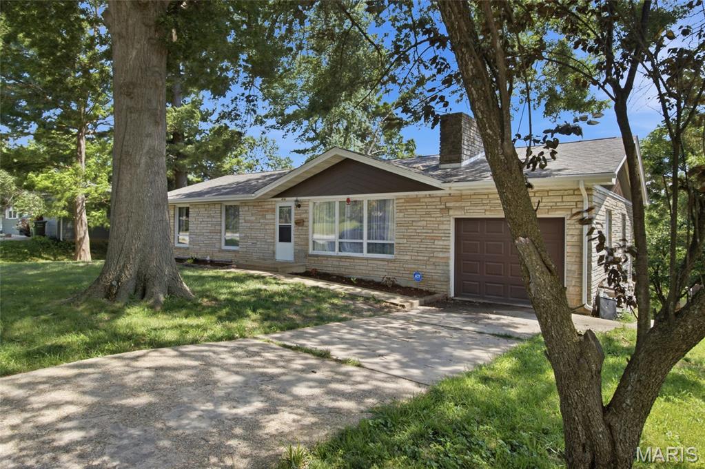 Rare opportunity to own a beautifully updated 5-bedroom home offering for under $250k! Finding this much space at this price point is becoming nearly impossible. Offering approximately 2,500 square feet, this updated 5-bedroom, 2-bath home combines space, style, and value in a quiet neighborhood close to schools, parks, and everyday conveniences. The home has been tastefully updated throughout, the standout feature is the impressive stone fireplace wall that stretches across the main living and dining areas, adding character and giving it a mid-century modern feel. The kitchen offers newer appliances, abundant cabinet and countertop space, a pantry, and a functional layout designed for everyday living. Just off the kitchen, the spacious dining area is highlighted by large windows that fill the space with natural light. With three bedrooms and a full bath on the main level and two additional bedrooms and a second full bath on the lower level, this home offers a versatile layout that works well for larger households, guests, teenagers seeking their own space, or anyone needing room for a home office, hobby area, or workout room. The lower level additionally offers another living area, storage, and large laundry room. Neutral colors and modern finishes give a move-in ready feel throughout the home. Additional features include an extended garage with a workshop area, generous storage, and updated finishes throughout. If you have been searching for a home that offers space, updates, and affordability, this property will not disappoint.
