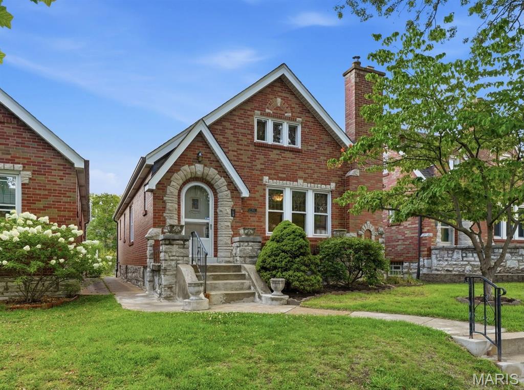 Looking for the perfect blend of classic St. Louis Hills charm and modern comfort? This beautifully maintained brick and stone story-and-a-half is filled with character, natural light, and inviting spaces you’ll love coming home to. Original hardwood floors, graceful archways, and a charming brick fireplace create a warm, welcoming atmosphere, while the spacious dining room flows into a bright eat-in kitchen with white cabinetry and plenty of workspace. Just beyond, the inviting sun room overlooks a beautifully landscaped, fenced backyard bursting with seasonal color—perfect for morning coffee, relaxing evenings, or entertaining friends. The flexible floor plan offers four bedrooms, including two on the main level that can easily serve as a primary bedroom, guest room, or home office. Upstairs, you’ll find two additional vaulted bedrooms and a convenient half bath. The updated full bathroom features beautiful stained glass, adding to the home’s timeless appeal. The clean, dry lower level offers outstanding storage and a newer HVAC system and water heater (2023), while the detached garage and additional off-street parking provide everyday convenience. Located just minutes from Francis Park, Ted Drewes, neighborhood restaurants, shopping, and all the amenities that make St. Louis Hills one of the city’s most beloved neighborhoods, this move-in ready home is full of charm, flexibility, and lasting value.
