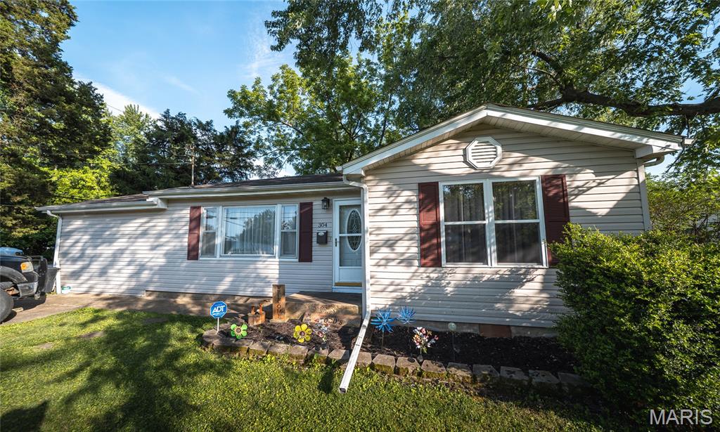 Step into comfort, convenience, and charm with this beautifully maintained 3-bedroom, 1.5-bath home perfectly positioned in a location that makes everyday living easy. Just a short walk from local grocery stores, restaurants, and daily essentials, this property offers the ideal blend of neighborhood living and in-town convenience. Inside, you’ll immediately feel at home with warm hardwood flooring welcoming you into the front room — a versatile space that could serve as a cozy living room, elegant dining area, or even a stylish home office. The spacious family room and bedrooms feature plush carpeting that creates a comfortable and relaxing atmosphere perfect for winding down at the end of the day. The kitchen has been refreshed with new appliances, making meal prep and entertaining both functional and enjoyable. Outside, the large flat yard offers endless opportunities for gardening, pets, play, or outdoor gatherings, while the fenced backyard provides added privacy and peace of mind. The concrete back patio is ready for summer barbecues, morning coffee, or evenings spent under the stars. Whether you’re searching for your first home, downsizing, or simply looking for a move-in-ready property in a convenient location, this home checks all the boxes. Schedule your private showing today and see everything this inviting property has to offer!
