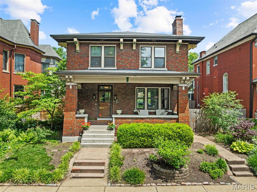 Nestled on a picturesque tree-lined street in the heart of Tower Grove, this brick stunner blends timeless character with thoughtful modern updates. A welcoming covered front porch sets the tone before stepping into a gracious foyer adorned with beautiful millwork. Folding doors open to a spacious living room anchored by a gas fireplace, while the sun-drenched dining room flows seamlessly into a stunning renovated kitchen designed to impress. Featuring a large center island, coffee bar, abundant natural light, and exceptional workspace, this is the kind of kitchen that becomes the heart of the home. Upstairs, the primary suite offers a peaceful retreat with a beautifully updated bath, walk-in closet, and light-filled bedroom. Two additional spacious bedrooms and an updated full bath complete the upper level. The finished lower level provides outstanding recreational space, a full bath, and walkout access to a private backyard oasis. Surrounded by mature foliage, the fenced yard features a large patio ideal for entertaining, relaxing, or dining al fresco, along with the convenience of a two-car garage. Charm, comfort, and modern amenities come together in one exceptional package, just moments from Tower Grove Park, some of St. Louis' most beloved restaurants, coffee shops, and convenient highway access.