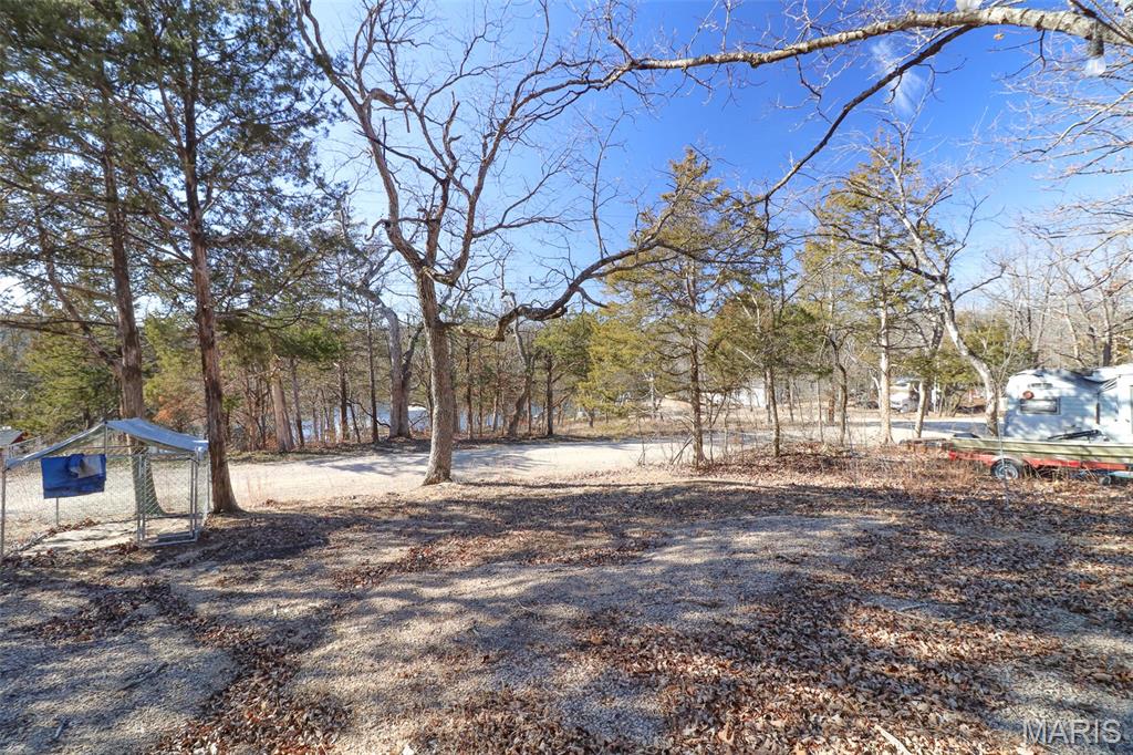 Love to camp and fish? Don't miss this opportunity to own your own double sized lot in beautiful Cedar Lake!  Lot features RV port, 200-gallon water tank, and storage shed. (items in shed are staying) Lot is water view and a short walking distance to the water.  Cedar Lake is a gated private community approximately an hour south of St. Louis. To find out more information go to cedarlakemo.com.  Set up your showing and experience all that Cedar Lake has to offer.