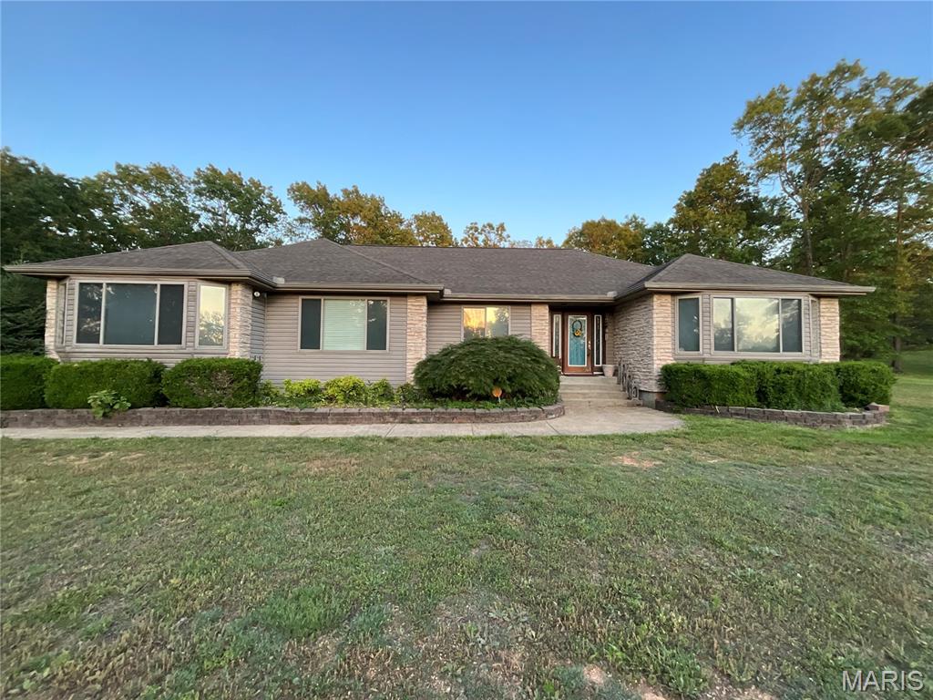 Executive Home on Hill Top Setting Just Outside of Town. Close to the Municipal Golf Course. Sits on 1.72 Acres—fenced rod iron back yard. Large Living Room with double-tray ceiling and can-lighting. Kitchen and Dining Room with tray ceiling. Country Kitchen with lots of Cabinets and Counter Space for Cooking! Large back deck partially covered. Fenced back yard for your children or fur baby! Indirect lighting—Bay Window - ADA accessible. Recessed light in double tray ceiling in the Living Room, LED 5/23. This home has a handicap shower/bars and a seat. 36'' doors, wheelchair ready. NO shelving stays in the garage. Soaking tub and Shower with a large walk-in closet. New flooring, Pantry, pull-out drawers, and generator backup. New Metal Storage shed with double lofts. This one is move-in ready! Sits on a dead-end road for lots of privacy, with all the conveniences.