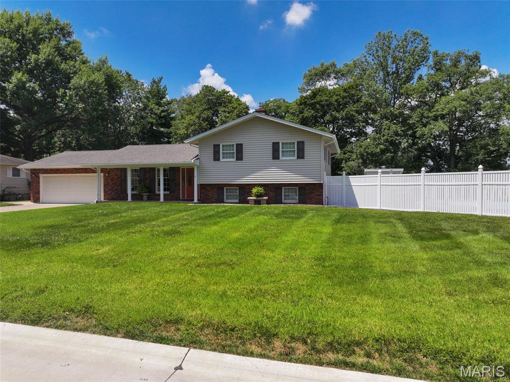 Located in the established Pointe Basse subdivision in Ste. Genevieve, this split-level brick home offers a functional layout, a spacious corner double lot, and outdoor amenities that complement everyday living. Conveniently located close to shopping, schools, restaurants, parks, and the many attractions throughout Ste. Genevieve, this property provides easy access to the conveniences of town while offering comfortable indoor and outdoor living spaces. The home's split-level design creates a practical separation between the primary living areas and additional flexible space on the lower level. Upstairs, you'll find three bedrooms and two full bathrooms, providing a comfortable arrangement for daily living. The primary bedroom includes its own full bathroom, while the additional bedrooms are served by a second full bath on the upper level. The main level features a kitchen that flows into the family room and dining area, creating an open and inviting space for gathering with family and friends. The layout allows everyone to stay connected whether preparing meals, enjoying dinner, or relaxing in the living area. Large windows bring natural light into the home while offering views of the surrounding yard. The lower level expands the home's usable space and includes a convenient half bathroom. This level provides flexibility for a recreation room, home office, workout area, hobby space, or additional entertainment area depending on your needs. One of the standout features of this property is its location on a corner double lot. The additional lot provides more outdoor space than many homes in the subdivision, offering room for recreation, gardening, landscaping, or simply enjoying the larger yard. The corner location also provides additional separation from neighboring properties and enhances the overall sense of space. Step outside onto the large covered back porch, an excellent place to enjoy your morning coffee, host cookouts, or unwind in the evening while overlooking the backyard. Just beyond the porch is the fenced in-ground swimming pool, creating an enjoyable outdoor setting during the warmer months. Whether spending time with family, entertaining guests, or relaxing poolside, this space adds another dimension to the property. A small storage shed is also located in the backyard and provides a convenient place to keep lawn equipment, gardening tools, and other outdoor items organized while freeing up space in the attached garage. The attached two-car garage provides protected parking along with additional storage for tools, recreational equipment, or seasonal items. The driveway also offers additional off-street parking for family and visitors. Pointe Basse is conveniently located within the city of Ste. Genevieve, placing you just minutes from grocery stores, restaurants, schools, parks, healthcare facilities, and the community's historic downtown district. The area also offers nearby recreational opportunities, local events, and access to the Mississippi River, making it easy to enjoy everything the community has to offer. The combination of a spacious corner double lot, functional split-level floor plan, and inviting outdoor amenities makes this home a standout opportunity in the Pointe Basse subdivision. From the large covered back porch and fenced in-ground swimming pool to the additional yard space and convenient storage shed, this property offers comfortable indoor and outdoor living while being just minutes from everything Ste. Genevieve has to offer.