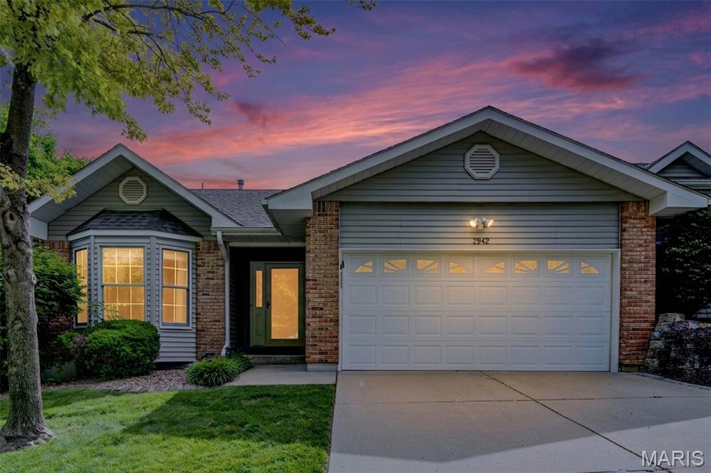 Welcome to 2942 Sylvan Lane in the desirable Oak Parc Villas community! This beautifully maintained villa offers 2,228 square feet of comfortable living space, featuring 3 bedrooms, 3 full baths, a finished lower level, and a beautifully landscaped yard that creates exceptional curb appeal.
Step inside to warm wood flooring that flows into the vaulted great room, where a cozy gas fireplace serves as the focal point. The adjoining dining room features a charming bay window, filling the space with natural light and providing the perfect setting for gatherings. The open floorplan flows to the breakfast room featuring a newer sliding glass door leading to a spacious deck, ideal for morning coffee, outdoor dining, or simply enjoying the peaceful surroundings.
The kitchen is both functional and inviting, showcasing beautiful wood cabinetry with crown molding, deep sinks, and a refrigerator that stays with the home. Retreat to the generous 16' x 12' primary suite features a convenient ensuite bath complete with a newly installed walk-in shower with dual built-in seats.  The second main-floor bedroom offers a bay window and ample closet space, while the hall bath includes a tub/shower combination and additional linen storage. Convenient main-floor laundry includes overhead cabinetry and a large storage closet that could easily serve as additional pantry space.
The finished lower level expands your living options with an impressive 24' x 18' recreation room flooded with natural light from three oversized picture windows. Two spacious walk-in closets provide exceptional storage rarely found in villa living. The third bedroom features a large egress window, while a full bath nearby offers comfort and convenience for guests. An expansive 18' x 22' unfinished utility room provides abundant storage space, a workbench, and endless possibilities for hobbies or workshop needs.
Conveniently located near shopping, restaurants, parks, and major highways, this move-in-ready villa combines low-maintenance living with the space and amenities you've been searching for. Don't miss this opportunity to enjoy comfortable villa living in a fantastic location!