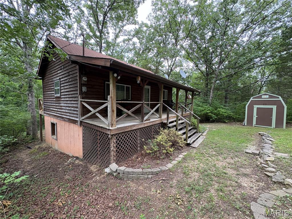 Lake Access! Secluded and furnished cabin nestled in the rugged, rural woods in the Lonedell Lakes private lake community on 2 decent sized lots at the end of the lane. Perfect for those weekend getaways or if you just want to downsize. You can capture all the amenities available of the 4 beautiful lakes in the subdivision and your home still not be seen by everyone as the home is surrounded by dense trees. You can enjoy fishing, swimming, picnics by the water or just take in the quiet views with natural scenery. Although there's plenty to offer for enjoyment here, this is probably the place where you will have the least amount of random visitors and would recommend an SUV or truck to get to the cabin. If you want time with rocks and trees, all the sounds of nature and an open campfire, then this home might be for you. You only have one other neighbor that you have to drive past that shares Monty lane with you and it's a good walking distance to the mailbox for sure. There's plenty of room for parking, adding a shop or garage, hot tub or pool, you name it. Whether you want to invite your fam and friends over or have it all to yourself, this place is ready to go. You'll find enough space in the living room on the main floor with kitchen and half bath. Full length front and back porches allow for downtime and enjoyment every day. Take the stairs to the basement to relax into the two bedrooms with full egress windows, a glass door walkout between them, full bath, laundry and utility room. Need more room for storage? There's a decent size shed waiting for you!  If you want quick access to I-44, you won't have to speed and can be in St Clair, Sullivan or Villa Ridge within 25-35 minutes (depending on how fast you drive). Take the time to schedule your viewing today and don't let someone else get this before you do!