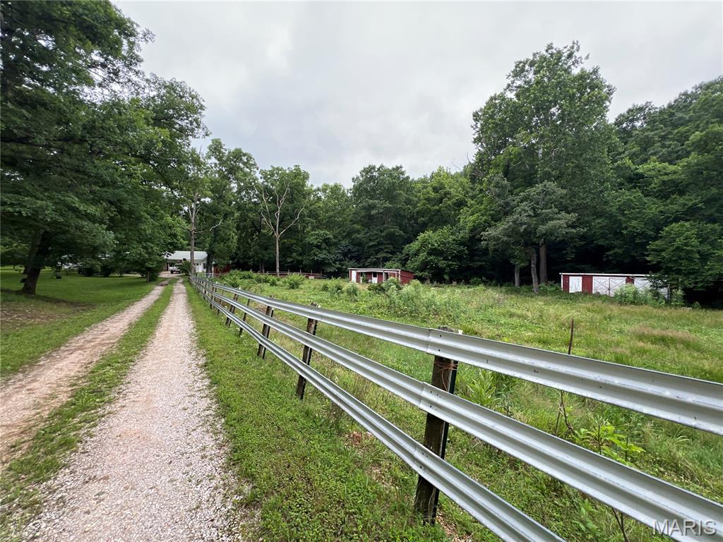 Fantastic hobby farm potential! This 4 bedroom 3 bath home on 2.8 acres is ready for your homesteading dreams. Featuring 2,818 sq. ft. of space, two attached garages, and a gorgeous pasture with pond and two small barns, the property offers a functional layout and great bones. Whether you want to plant gardens, raise animals, or just enjoy the wide-open peace and quiet, this property delivers. Schedule your tour today! Property sold As Is.