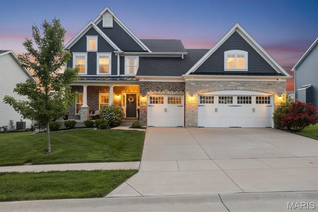 This exceptional like-new 1.5-story offers exquisite craftsmanship, modern design and plenty of square footage. The attractive landscaping, brick & stone facade, and covered front porch create an unforgettable first impression.  From the moment you step inside, the home’s refined character and meticulous attention to detail are unmistakable showcasing wood flooring throughout the main living areas, crown molding, 9' ceilings and open floor plan all complemented by an abundance of natural light.  Every space has been designed to feel both inviting & sophisticated, creating an atmosphere that is equally suited for everyday living and entertaining.  The stunning designer kitchen includes custom cabinetry, high-end finishes, built-in ovens, herringbone pattern backsplash, walk-in pantry, and a large center island that effortlessly opens into the great room and breakfast room/coffee bar area-- which reinforces the home’s open floor plan and ensures that gatherings feel connected & comfortable.  The adjacent hearth room offers a cozy retreat anchored by its warm ambiance and framed by views of the backyard.  A primary bedroom with custom windows, en suite with dual vanities, soaking tub, walk-in shower, water closet, and large walk-in closet; laundry/mud room, and powder room complete the main level.  The upper level with new carpet is highlighted by a secondary bedroom suite, two additional bedrooms serviced by a Jack & Jill bathroom, and loft space perfect for a kid's reprieve!  The finished lower level expands the home’s living space even further with huge rec room, 5th bedroom, full bathroom, and bonus room perfect for an office. Beyond the home itself, the neighborhood elevates the lifestyle even further. Located in one of STL's most prestigious and sought-after communities, residents enjoy access to an impressive array of amenities designed to enrich everyday living. A stunning 20-acre lake with walking path serves as the centerpiece of the neighborhood, offering opportunities for fishing, relaxation, and scenic enjoyment. Also include in this amenity-rich community are multiple playgrounds, pavilions, pickleball courts and an abundance of common ground.  As demand continues to grow for Fienup Farms, homes in this area are becoming increasingly sought after, making this property not only a beautiful place to live but also a compelling long-term investment!