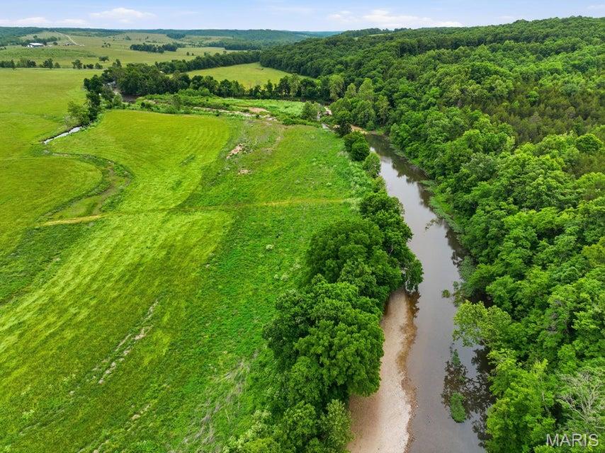 522 Acres m/l of premier recreational and investment property featuring 1/2 mile of the beautiful Roubidoux Creek along with a natural spring offering an additional valuable water source. Burkhart Branch runs right through the middle of the property as well. This breathtaking property offers a rare combination of scenic beauty, privacy, and usability with multiple gorgeous building sites perfect for your dream home, hunting lodge, or weekend retreat. Established trails run throughout the property providing excellent access for ATV riding, horseback riding, hiking, and exploring the diverse terrain. Electric is already on the property, making future development even more convenient. The acreage offers a great mix of mature timber, open areas, rolling terrain, creek frontage, and abundant wildlife habitat creating exceptional hunting and outdoor recreation opportunities. Whether you are searching for a private getaway, recreational paradise, cattle or hunting property, or long-term investment, this property offers endless possibilities. Enjoy the peaceful setting, scenic views, live water, and endless outdoor opportunities all within one incredible tract of land. Large acreage properties with Roubidoux Creek frontage, a spring, trails, and utilities already in place are becoming increasingly hard to find.