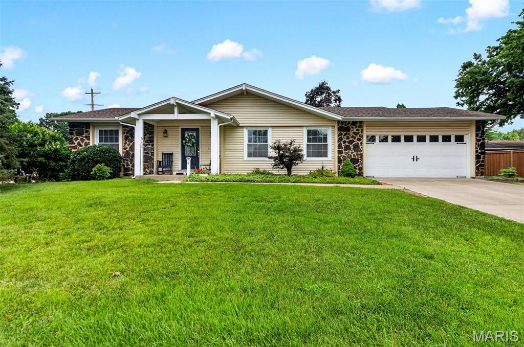 Welcome home to this beautifully maintained ranch at 2 Park Charles Blvd in St Peters!! This move-in ready gem sits on a lush, manicured lot with great curb appeal, a covered front porch, and an attached 2-car garage. Inside, gleaming hardwood floors flow through an inviting living room with a stunning stone fireplace, an elegant formal dining area, and a spacious eat-in kitchen with ample cabinetry and counter space. The main level offers generously sized bedrooms, including a primary suite, plus a versatile bonus room with a wet-bar/craft area- perfect for hobbies or extra storage. Downstairs, the expansive finished basement adds incredible flexible living space with room for a rec area, home gym, or media room, plus a bonus room that could be used as an additional room to put a bed, half bathroom and abundant storage/workshop space in the unfinished portion. Enjoy peaceful evenings on the patio overlooking the fenced backyard. Don't miss this rare combination of space, updates, and location! Schedule your showing today; houses in this area do not last long.