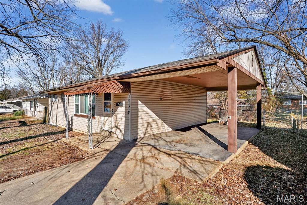 Charming one-story ranch home offering comfortable living and great functionality! This 3-bedroom, 1-bath property features a covered entry and attached carport, welcoming you into a bright interior filled with natural light and neutral colors.

Inside, you'll find beautiful hardwood floors and a spacious living room that provides plenty of room for relaxing or entertaining. The kitchen features a stylish tile backsplash and a gas range, creating a practical and inviting space for cooking and gathering.

The full basement adds excellent versatility with a built-in workbench and storage shelves already installed—perfect for projects, hobbies, and extra storage. Outside, the fenced yard offers space for pets, gardening, or enjoying the outdoors.

With classic ranch-style charm and useful features throughout, this St. Louis home is ready for its next owner to move in and make it their own!