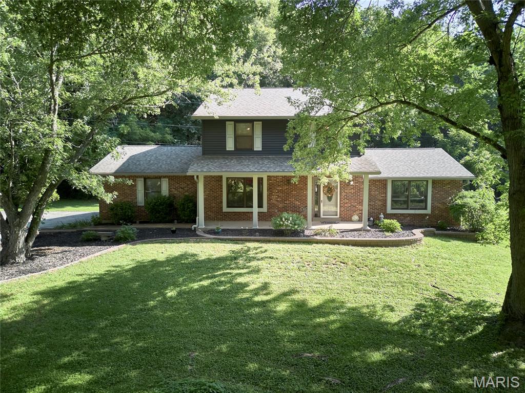 Welcome to 3851 Autumn Set Dr. in Arnold! Nestled on 2 acres , this meticulously maintained one-owner home offers over 3,000 square feet of finished living space with 4 bedrooms and 4 bathrooms. The exterior features a timeless brick front, newer siding 2022, a roof replaced in 2018, and new gutters in 2019. Step inside to beautiful original hardwood floors and a striking two-sided wood-burning fireplace that creates a warm connection between the living and dining areas. The kitchen is equipped with custom cabinetry and granite countertops, while the main level also includes a convenient laundry room and half bath. Upstairs, you'll find four spacious bedrooms and two full bathrooms. The primary suite features a beautifully remodeled bathroom (2025), and new luxury vinyl plank flooring was installed throughout 2 of bedrooms and office in 2025. The lower level offers additional finished living space, a half bath, and plenty of unfinished storage. This exceptional property has been lovingly cared for and is ready to welcome its next owners. Schedule your private showing today!