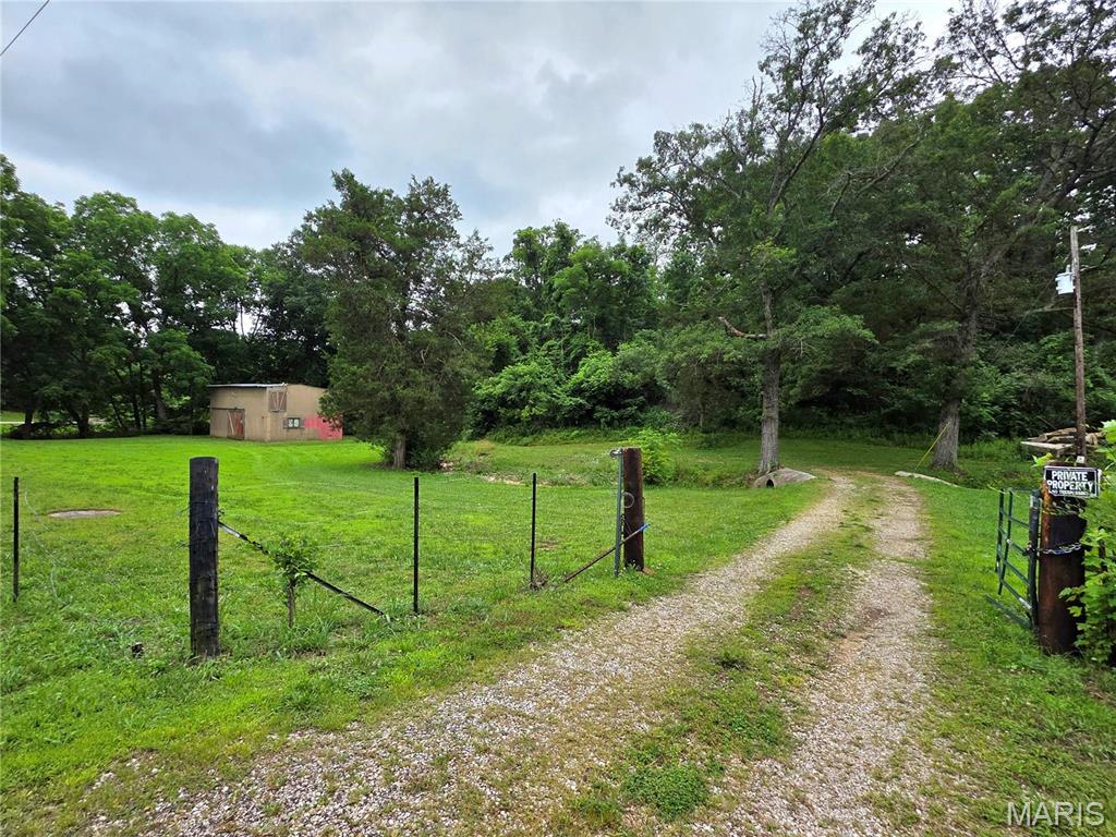 Here's What You've Been Looking For!  Situated at the corner of Highway JJ and Wild Oak Road this 11 acres would be the perfect place for your new home.   There is an outbuilding, a well and electric on the property (from previous house which is no longer there) and fire pit for your enjoyment. You will love the peace and quiet here.  Build you forever home, hunt, bring your RV, camp.....you decide!  Whatever you decide you'll be sure to enjoy it!