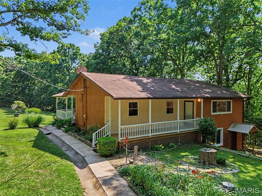 Escape the hustle and discover your own private retreat!

If you've been searching for privacy, room to roam, and no restrictions, this 15-acre property is the one you've been waiting for. Nestled among nature, where your closest neighbors are often deer and wildlife, this property offers the peace and freedom that's hard to find.

The home features 2 bedrooms and 1 bathroom on the main level, while the walkout lower level offers 1 bedroom and 1 bathroom, making it an excellent option for multi-generational living. The lower level also includes its own private entrance, living room, and kitchen, providing flexibility for extended family, guests, or separate living quarters.

Whether you're dreaming of a hobby farm, outdoor recreation, or simply enjoying the beauty of country living, this property offers endless possibilities—all located within the highly sought-after Seckman School District.

Privacy. Acreage. Flexibility. Freedom. Come experience all this incredible property has to offer!