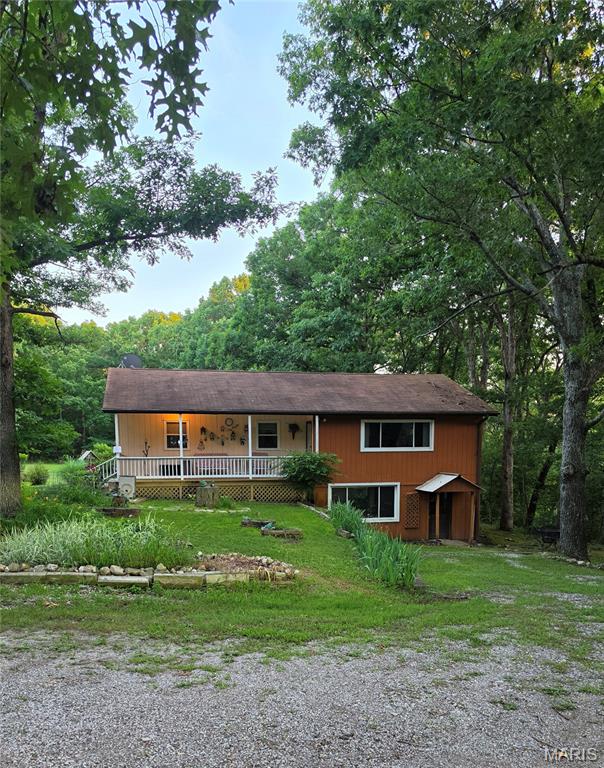 Escape the hustle and discover your own private retreat!

If you've been searching for privacy, room to roam, and no restrictions, this 15-acre property is the one you've been waiting for. Nestled among nature, where your closest neighbors are often deer and wildlife, this property offers the peace and freedom that's hard to find.

The home features 2 bedrooms and 1 bathroom on the main level, while the walkout lower level offers 1 bedroom and 1 bathroom, making it an excellent option for multi-generational living. The lower level also includes its own private entrance, living room, and kitchen, providing flexibility for extended family, guests, or separate living quarters.

Whether you're dreaming of a hobby farm, outdoor recreation, or simply enjoying the beauty of country living, this property offers endless possibilities—all located within the highly sought-after Seckman School District.

Privacy. Acreage. Flexibility. Freedom. Come experience all this incredible property has to offer!