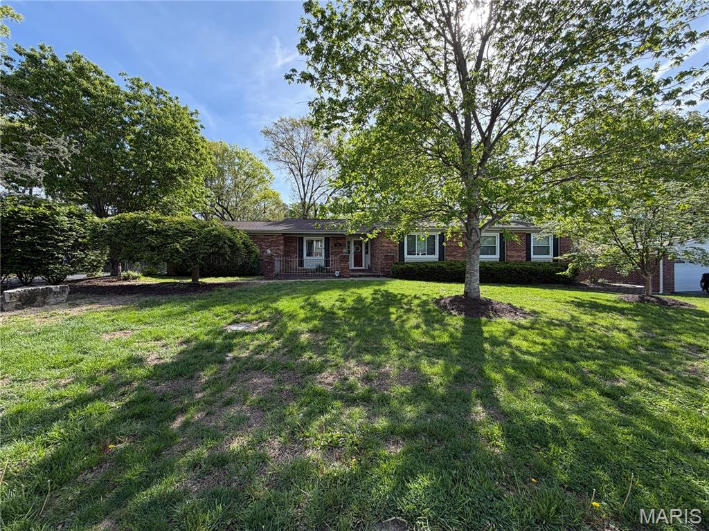 Located in the highly sought after Cherry Hill West community, this ranch-style residence is the perfect place to write your next chapter. With 3 bedrooms, 3 full bathrooms and over 3,000 square feet of living space, this home is the one you've been waiting for! Step inside to find a layout designed for effortless living, with a formal dining room, spacious living room w/gleaming hardwoods, and cozy family room w/beamed ceilings & fireplace! The heart of the home is a kitchen built for the culinary enthusiast, uniquely equipped with dual cooktops ideal for holiday hosting or impressive meal prep. The screened in porch is the perfect place to enjoy that morning coffee or unwind after a long day. Beneath the current carpet lie original hardwoods waiting for their moment to shine! Downstairs, the walkout lower level adds incredible versatility with a large media room, a dedicated office or sleeping area, and a third full bathroom. Recent updates provide peace of mind, including a new furnace w/humidifier (2024) and some new windows (2025) in key living areas. Outside, a fully fenced backyard offers privacy and room to play!  Located in a premier location in the Marquette boundary of Rockwood School District with easy access to everything, this home isn't just a place to live; it's an opportunity to build equity and make memories for years to come! The Wolf Cafe will be your new hang out, just steps from home! Don't miss this one - schedule your showing today!