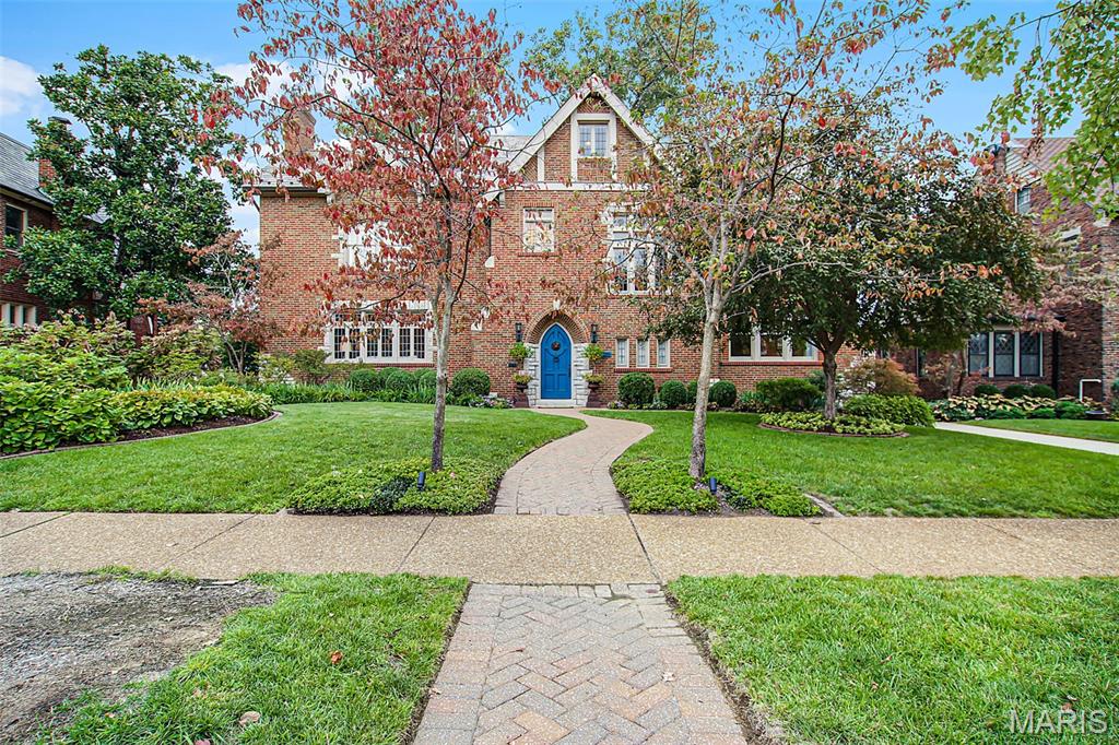 Steps from Forest Park:  Classic 1930 Tudor Revival in Clayton’s Ellenwood Subdivision.  Incredible preservation of the craftmenship of the 30's with, believe it or not, the original door handles that are hammered brass.  The epitomeThe house combines timeless architecture with thoughtful updates. 4,316 sq. ft. of elegant living includes four bedrooms plus a private den/office and an upper-level suite ideal for guests, teens, or creative use, along with three full and two half baths. Every space adapts easily to the way people live and work today. The traditional floor plan offers defined rooms that flow naturally, with a family room opening to a deck and a large, landscaped yard. The kitchen, renovated within the past five years, features an induction cooktop, double ovens, Sub-Zero refrigerator, and built-in banquette. Upstairs, the primary suite includes an updated bath with soaking tub, walk-in shower, and double vanity; additional bedrooms share a Jack-and-Jill bath. The third floor offers flexible space for guests, work, or play. The lower level provides a casual gathering area, laundry room, half bath, and two-car garage. Within a block of Forest Park and located in Captain Elementary, this home pairs 1930s craftsmanship—slate roof, leaded-glass windows, and ornate plasterwork—with the comfort and versatility of modern living.The kitchen, renovated within the past five years, features an induction cooktop, double ovens, Sub-Zero refrigerator, and built-in banquette. Upstairs, the primary suite includes an updated bath with soaking tub, walk-in shower, and double vanity; additional bedrooms share a Jack-and-Jill bath. The second floor bedrooms have custom built-ins and the closets throughout the home are custom organized.  The third floor, originally designed as a suite for two teens, now offers ideal space for kids, guests, creative pursuits, or a quiet retreat. The lower level provides a casual gathering area, laundry room, half bath, and two-car garage. The slate roof was replaced approximately 25 years ago.  Within a block of Forest Park and located in Captain Elementary, this home pairs 1930s craftsmanship—slate roof, leaded-glass windows, and ornate plasterwork—with the comfort and versatility of modern living.