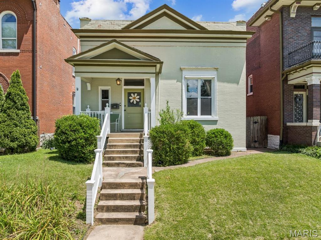 Some homes just feel right the moment you walk in. This Tower Grove East brick home with Greek Revival charm is one of them — beautifully maintained, rich with historic character, and set on one of the neighborhood’s most beloved blocks. Inside, hardwood floors, pocket doors, period millwork, and two classic mantels with stunning tile surround details give the home the kind of warmth and craftsmanship you simply can’t recreate. The living and dining rooms flow beautifully, offering an easy layout for everyday life or entertaining.

The kitchen blends clean, modern function with generous cabinet storage, updated countertops, stainless appliances, and a refrigerator that stays. The spacious main bath features a double vanity, while the bedroom includes two closets and direct access to the deck. Downstairs, the finished lower level expands the living space with a large rec room, cheerful additional sleeping area, full bath, laundry closet, and serious storage.

Recent updates offer peace of mind, including a new HVAC system in 2022 and a fresh roof coating in 2022. Outside, enjoy a fenced backyard, large deck, and two-car garage-port. All of this just two blocks from Tower Grove Park and an easy stroll to Crafted, Tick Tock, Riley’s, and the South Grand corridor. Tower Grove East living at its best.