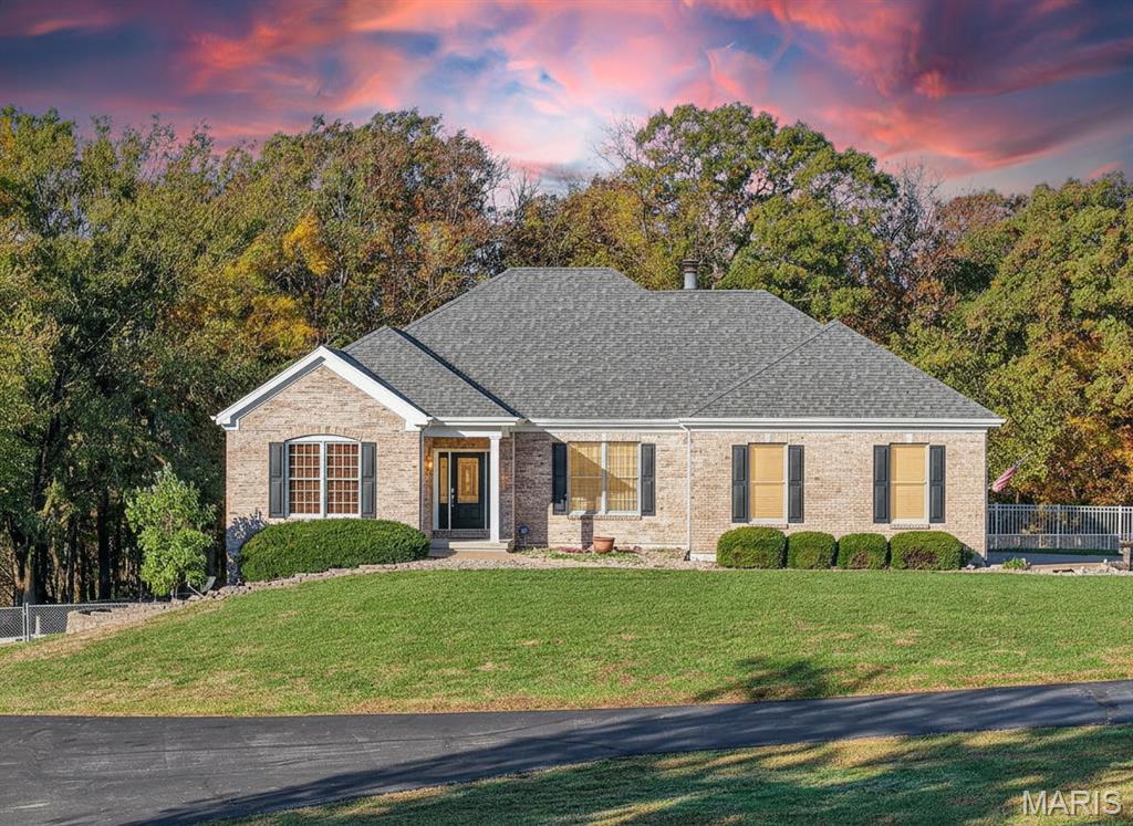 Imagine a custom-built ranch perfectly situated on almost 7 acres with a massive 80x40 detached garage...almost 3,200sqft — ideal for the car enthusiast, RV owner, boater, or anyone needing a serious workshop! It even has a bathroom with shower. The third bay features an extra-tall door and taller ceilings designed for RV, camper, or boat storage.  Located in Lake St. Louis, just minutes from Hwy 40/61 and Quail Ridge Park, this stunning ranch offers gorgeous curb appeal with a full brick front, professional landscaping, hip roof, and Andersen windows.  Step through the decorative glass door into a grand entry with marble flooring that opens to an inviting, open-concept layout featuring 10-foot ceilings, gleaming hardwood floors, and a wall of windows flooding the space with natural light.  The chef’s kitchen includes staggered 42-inch cabinetry, solid-surface counters, stainless steel appliances, abundant counter space, and a gas see-through fireplace that connects to the large vaulted great room.  Enjoy outdoor living on the low-maintenance vinyl deck overlooking the expansive, fenced yard.  The finished walkout lower level offers two additional bedrooms, a full bath, a spacious family room, and generous storage.  So many unique features make this home truly special — schedule your private showing today!