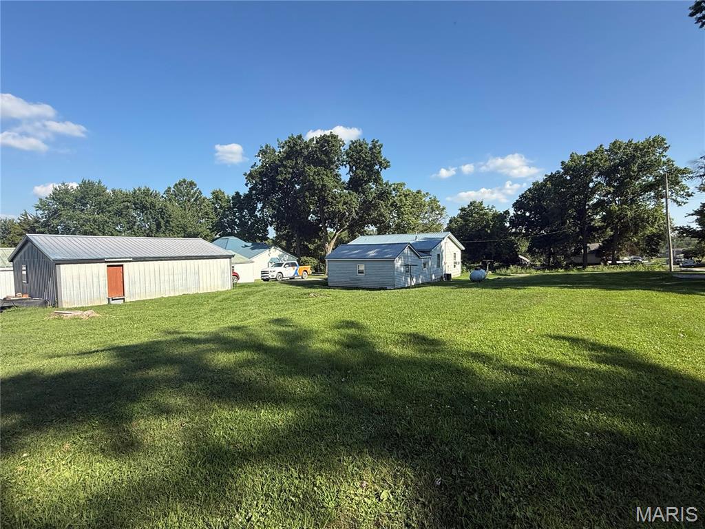 Discover this charming 1,176 sq ft bungalow situated on 6 city lots, totaling approximately 1.0 acres, in the heart of Brashear, Missouri. Recently renovated and meticulously maintained, this home boasts a brand-new roof installed in 2023, ensuring peace of mind for years to come. Inside, you'll find all-new flooring, fresh paint, modern appliances, and a beautifully updated bathroom, all completed in 2025. The layout is both functional and inviting, offering ample living space for families or those seeking a cozy retreat. The property features a spacious 3-car garage, providing plenty of storage for vehicles, tools, or hobbies. The expansive lot offers abundant outdoor space, perfect for future expansions of the home or the opportunity to build a custom shop tailored to your needs.
This bungalow combines modern updates with the charm of city living, making it an ideal choice for those looking to settle in Brashear.