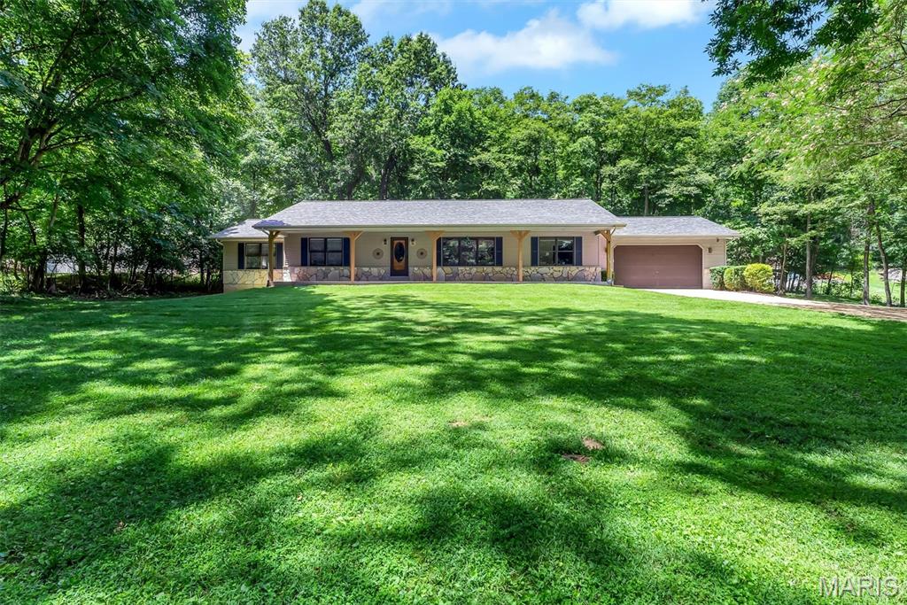 Welcome to 2469 Wild Valley Drive! Meticulously maintained and nestled on approximately 2 beautiful acres, this exceptional ranch offers the perfect blend of comfort, quality, and peaceful surroundings. Step inside to a stunning vaulted living room accented by white oak hardwood floors throughout the main living areas and 3/4" hickory hardwood flooring in all bedrooms. The refreshed kitchen is designed to impress with quartz countertops, soft-close cabinetry, under-cabinet lighting, and a spacious pantry. The primary suite features a beautifully updated bath with radiant-heated floors, a double vanity, and a relaxing retreat feel. A convenient main-floor laundry room includes a built-in desk area and adjoining half bath. The finished lower level boasts 9-foot ceilings, a kitchenette, full bath with fun custom tile finishes, and its own exterior entrance—ideal for guests, multi-generational living, or entertaining. Outside, unwind on the patio while enjoying the surrounding nature, with additional features such as a detached shed, a garage service door, and room to roam on this picturesque property.