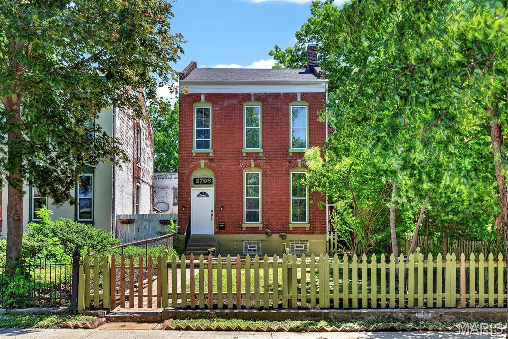 Experience the best of historic Saint Louis living in the heart of Benton Park! This classic brick home blends timeless architectural character with modern comfort just steps from Benton Park, local restaurants, coffee shops, neighborhood bars, and some of the city’s most loved destinations. Inside, soaring ceilings, oversized windows, original hardwood floors, and abundant natural light create a warm and inviting atmosphere throughout. The grand curved staircase makes an unforgettable first impression while the rare second staircase and rear entry provide added convenience and flexibility. Spacious living and dining areas offer plenty of room to entertain while multiple gathering spaces create options for a home office, lounge, reading room, or media space. The updated kitchen features extensive custom cabinetry, granite countertops, stainless steel appliances, gas range, and exceptional storage rarely found in city homes. Refrigerator plus washer and dryer are all included, making the transition into your new home even easier. Upstairs, the oversized primary suite offers generous space and connects to an expansive dressing room and closet area that feels truly unique for the neighborhood. Outside, enjoy mature trees, fenced outdoor space, and classic Benton Park charm on one of the area’s iconic streets. Major systems have already been updated with newer HVAC and water heater and roof approximately 9 years old, offering peace of mind for the next owner. Full of historic charm, this Benton Park gem offers flexible living, incredible walkability, and the opportunity to own a true piece of Saint Louis character. Floor plans are included at the end of the photographs section.