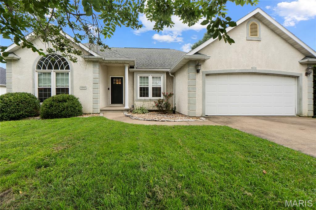 Welcome home to this charming villa-inspired ranch located in the highly sought-after East Elementary School district in Jackson. With its stucco exterior, arched architectural details, and beautiful new front door, this home offers timeless Greek villa vibes and standout curb appeal.
Step inside to find fresh paint throughout the main level, new flooring in the main level bedrooms, and a spacious living room featuring soaring vaulted ceilings and a cozy reading nook that makes the space feel both grand and inviting.

The kitchen offers a new refrigerator, pantry, and a charming built-in breakfast nook with custom seating that's perfect for morning coffee or casual meals. Just off the kitchen is a separate formal dining room accented by beautiful architectural arches and the perfect niche for a credenza, buffet, or coffee bar setup.

The main level also offers convenient laundry and an attached two-car garage. Downstairs, the finished walkout basement expands your living space with an additional bedroom, full bathroom, spacious family room, and a dry bar that's ideal for entertaining guests or hosting movie nights.

Enjoy outdoor living from the covered deck overlooking the fenced backyard, or step down to the patio just off the walkout basement for even more space to relax and unwind.

Conveniently located just minutes from I-55 access, this home combines unique character, thoughtful updates, and an unbeatable location in the desirable East Elementary School district.