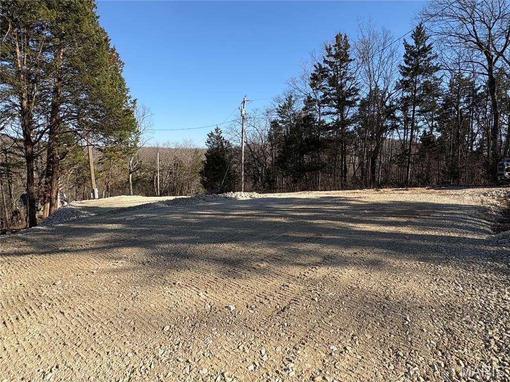 Beautiful Turnkey 0.26-acre lot in Pinnacle Lake! The lot is set up with electric, (Disconnected currently) a holding tank, a four-car parking area, and an expansive gravel lot ready to park your camper or build you dream lake retreat. The lot lays mostly level and is very private, yet only steps from an association owned boat ramp and swimming area. This property is ready for you to pull your camper in and spend the summer Enjoying the 130-acre community lake that boasts excellent swimming, boating, and fishing. The view of Pinnacle Rock jutting out of the water is nothing short of awe inspiring. There are also miles of community roads to cruise your SXS and get to know the neighbors. Pinnacle Lake is a private, gated community less than an hour from Mid Rivers Mall. Making this a great alternative to some of the larger lake getaways.