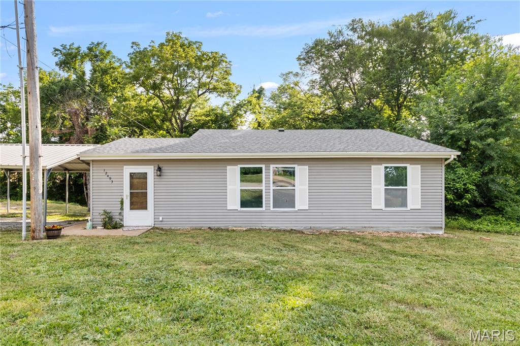 Look no further than this spacious ranch on over half an acre in Festus! You'll have a great mix of cleared and wooded areas in the picturesque yard, perfect for grilling with friends on the patio or sitting around a bonfire on a chilly evening. A charming bridge takes you to the secluded outdoor space surrounded by mature trees. There's also plenty of space for all of your vehicles, with a covered carport and extra parking. Inside, the foyer opens to a bright living room with laminate floors that continue throughout. Off the living room is a dining room that could also function as a home office. The eat-in kitchen features tile floors, recessed lighting, and tons of cabinet and counter space. The primary bedroom has a walk-in closet and en-suite bathroom. Two more bedrooms, another full bathroom, and a convenient laundry room complete the main level. The unfinished basement adds storage space. You'll have the best of both worlds: your own private space while also just moments from schools, I-55, and downtown Festus. Don't miss out!