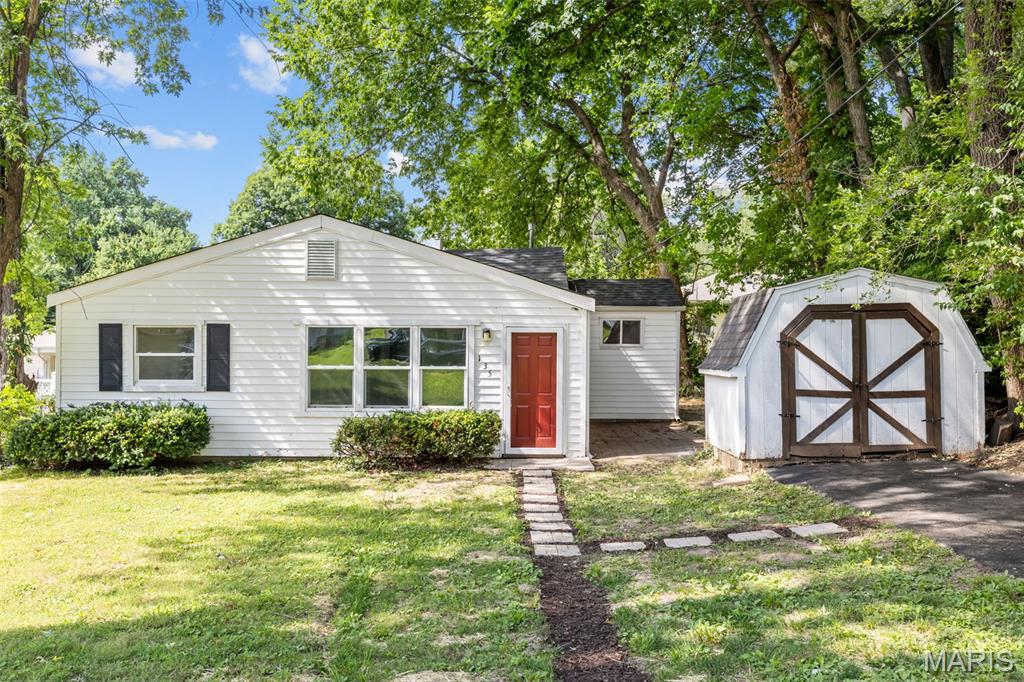 Look no further than this move-in ready ranch in Hazelwood! A large front yard shaded by trees leads you inside to the bright living room. You'll love the abundance of natural light and painted wood floors that continue into all three bedrooms. The kitchen features stainless steel appliances and new LVP flooring. Off the kitchen is a charming room with built-in shelves that could serve as a dining room or bedroom. Two more spacious bedrooms, a full bathroom, and a laundry/utility room complete the space. You'll have extra room for storage in the shed, plus off-street parking. Moments from McCluer schools, with quick access to I-170 and I-270, this great home in a convenient location is one you won't want to miss!