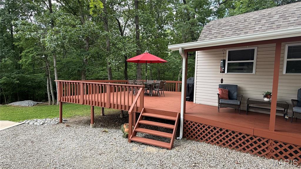 Gated lake community just 45 mins south of St. Louis! Looking to escape for a weekend getaway or full-time residence, this charming one- bedroom, one-bath, full kitchen cabin offers the ideal blend of relaxation, recreation, and community living. Situated on 4 level lots totaling over an acre corner lot, this well maintained property provides plenty of room to spread out and enjoy the outdoors. Spend your evening relaxing on the spacious deck, hosting BBQ's, gatherings and making unforgettable memories with family and friends. There's ample parking for boats, side-by-sides, razors and guest. The property also features 2 RV hookups, complete with electric, well water and holding tank- perfect for future building add on's. Need extra storage or room to expand, you'll love the outbuilding that could easily be converted into additional living space, along with a convenient carport with a small workshop /storage area. The gated lake community itself offers over 400 acres of enjoyment including fishing lakes, beach, boat slips, playground, recreational areas and a community pool. More than just a neighborhood, this gated community is a place where friendships are made and lifelong memories begin. At this price point, opportunities like this rarely come along.. Start living the lake life TODAY!!