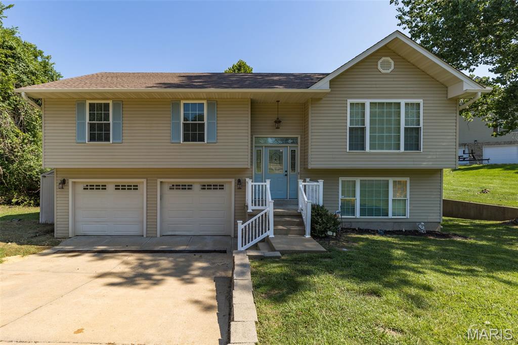 Wake up to breathtaking waterfront views in this beautiful lakefront home on Lac Carmel in the sought-after Terre Du Lac community! Offering over 2,000 square feet of living space, this spacious split-foyer home features a 2-car attached tuck-under garage and a fully finished walkout basement with a large family room, full bath, and a possible fourth bedroom with egress windows. The upper level boasts an open-concept design with vaulted ceilings, three bedrooms, and two full baths. The inviting living room features an electric fireplace and opens to a spacious deck overlooking the lake. The kitchen is equipped with custom cabinetry, stainless steel appliances, and a convenient breakfast bar/island, making it perfect for entertaining. Step outside from the walkout basement to a beautiful patio leading to a scenic boardwalk and your private dock for easy lake access. Enjoy the incredible Terre Du Lac lifestyle with boating, fishing, swimming, golf, and numerous community amenities just outside your door. This is lake living at its finest!