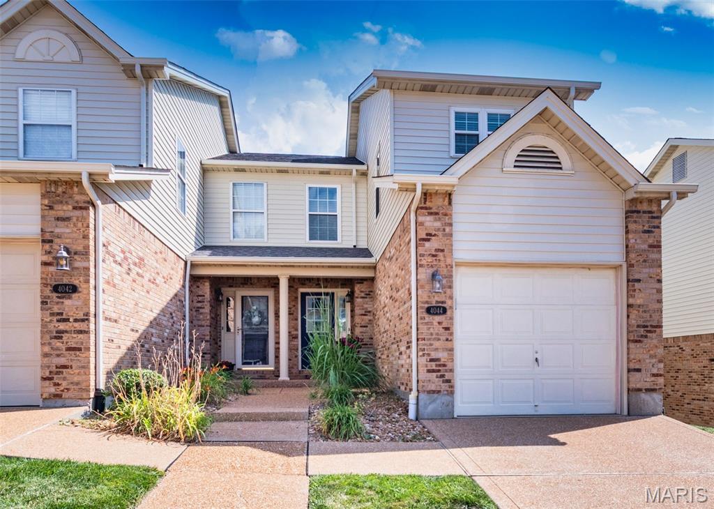 Showings start Thursday, July 9.  Searching for the perfect townhouse?   Well your search ends here!  This wonderful end-unit townhouse offers approximately 1,762 square feet of comfortable living space with 2 bedrooms and 2.5 bathrooms. An attractive landscaped walkway welcomes you to the covered front porch. Upon entering you will find a foyer with luxury vinyl flooring that opens to the bright and inviting great room.  It features large windows, custom built-in bookcases, and French doors leading to one of the largest decks in the community—an ideal space for relaxing or entertaining while enjoying peaceful views with trees. The adjacent dining area is highlighted by a charming bay window. The updated kitchen is sure to impress with rich wood cabinetry featuring soft-close drawers, granite countertops, a pantry and stainless steel appliances that are all included. A convenient half bath completes the main level.  Upstairs, you'll find a spacious primary suite that includes a large walk-in closet and a beautifully updated ensuite bath with a walk-in shower and oversized vanity. The generously sized second bedroom also features an updated private bath with a tub/shower combination. The finished lower level provides even more living space with a recreation room complete with a bar that stays, along with a laundry area and storage space. Additional highlights include a new roof (2026), an attached one-car garage, nearby guest parking, newer windows, and an unbeatable end-unit location. This move-in-ready home combines style, comfort, and convenience—don't miss your opportunity to make it yours!