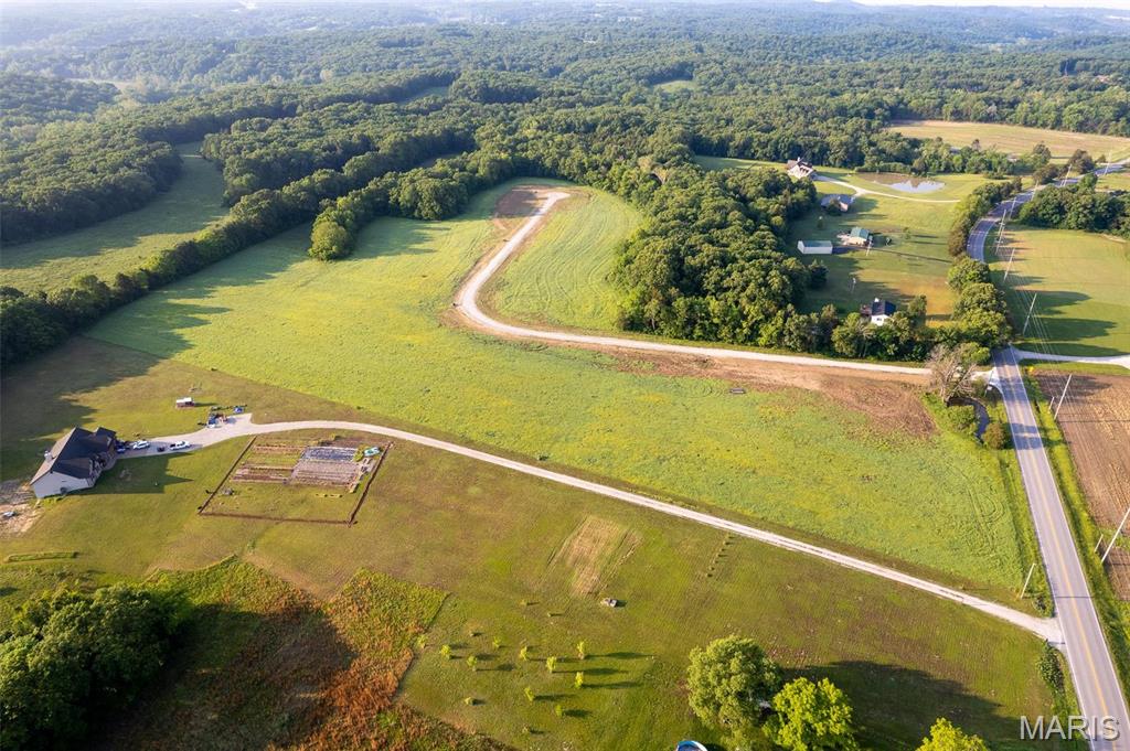 This level open building lot is part of a small, platted five-lot subdivision, featuring reasonable restrictions and a $300 annual association fee.  This lot is roughly 721 feet deep but also has 399 feet of highway frontage, providing excellent accessibility for car enthusiasts.  A charming spring fed pond is located on the common ground at the entrance of the subdivision, adding to the natural appeal.  Conveniently situated just 15 minutes from shopping in Washington, MO and 20 minutes from Wentzville, MO and only minutes from award winning wineries.  This property falls within the Francis Howell School District. Don't hesitate as this is the only lot available.  In Platted Subdv.
