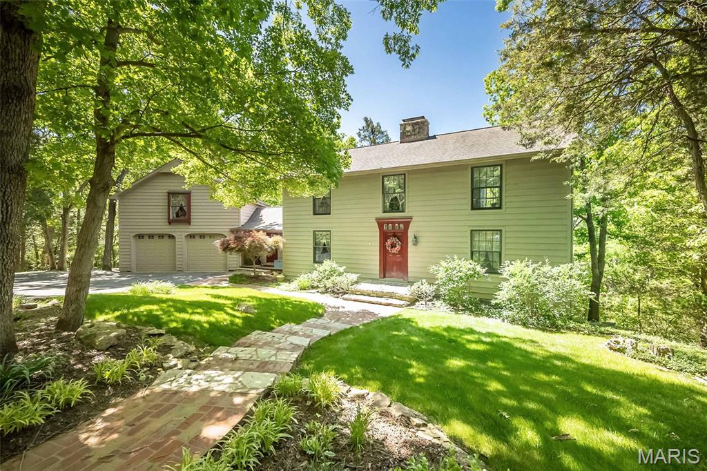 Nestled on a sprawling 3.8-acre estate, this colonial-style home seamlessly marries historic charm with modern elegance. Crafted with many quality, reclaimed materials—including authentic wagon beams, true 2x14 inch floor joists, and 12-inch pine planks sourced from a historic school—every detail exudes character.  The home offers multiple living areas including a finished basement with wood burning stove and a 460 square foot loft above the garage with it's own entry and rough in plumbing. This would make for the perfect art studio, office, or guest quarters. The primary ensuite offers a jetted tub and 2 large walk in closets. The secondary bedrooms share a hall bath and there is a third full bath on the main level. Dual zones and a whole house wood burning furnace ensure the perfect climate control in any season. The  center, stone encased fireplace extends to the second level and provides passive heating for the large breakfast/hearth room, and entry way. This amazing home as been featured  twice in Better Homes and Gardens publications - it's special!! Tucked away in serene privacy with manicured grounds and multiple sitting areas to enjoy this heavily wooded property. It’s a rare sanctuary within 20 minutes from all amenities. Top rated Rockwood schools and Jefferson County taxes  are hard to beat. Outdoor opportunities abound! The community offers two lakes, one for wading or sunning on the sandy beach area and a larger one for fishing opportunities. Enjoy hiking? This is located within 5 minutes to hundreds of acres of conservation land including La Barque Creek, Young, and Glassberg. These are some of the finest outdoor destinations in Jefferson County, with miles of trails through scenic bluffs and watersheds. Experience this one-of-a-kind retreat—your private, storied oasis awaits.