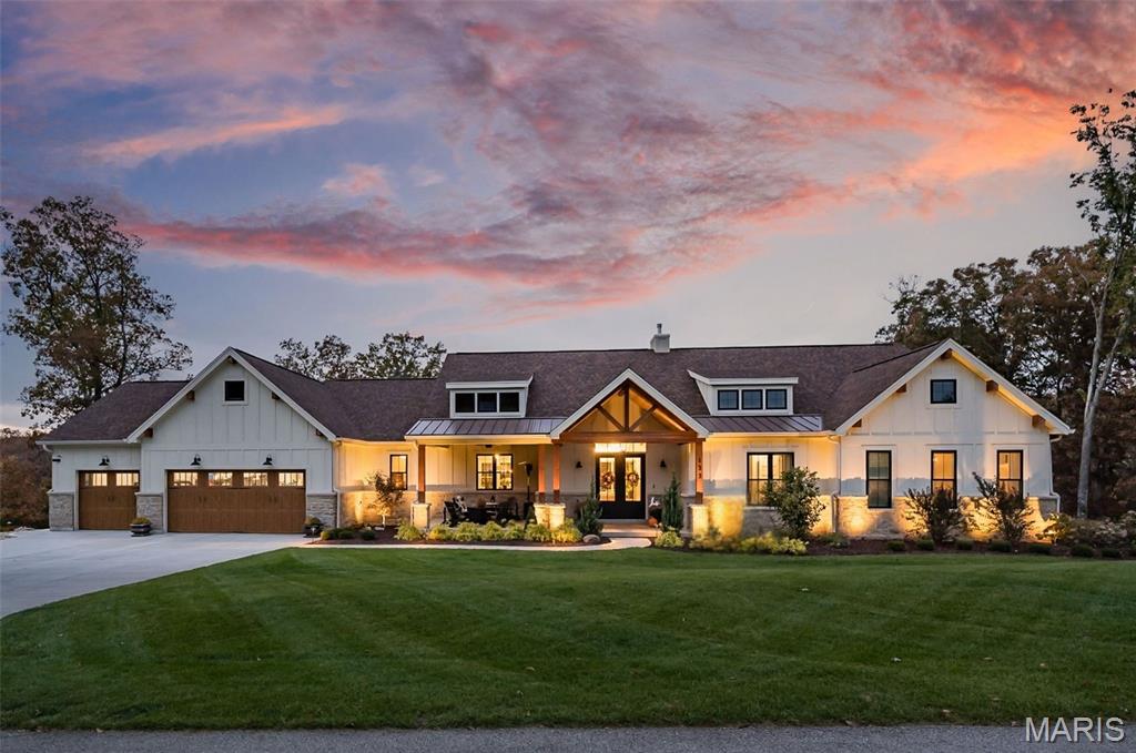 Welcome to your private retreat on 2.58 acres in Troy where peaceful country living meets thoughtful design and incredible recent upgrades. Surrounded by woods, this property invites you to slow down, spread out, and truly enjoy where you live.

Inside, a dramatic great room makes an unforgettable first impression with soaring ceilings, exposed Douglas fir beams, a striking masonry stone fireplace, and walls of windows that fill the space with natural light. The open floor plan flows seamlessly into the chef’s kitchen, featuring a large center island and newer premium Thermador appliances, including refrigerator, range, dishwasher, and a sleek microwave drawer. The walk-in butler’s pantry offers added cabinetry and a beverage refrigerator. You’ll love the organized mudroom off the garage with custom cabinetry, granite counters, utility sink, and doggy bath, along with a beautifully finished main-floor laundry room complete with additional cabinetry, granite counters, a sink, and space for a morning espresso bar.

The main level has been thoughtfully enhanced with new hardwood flooring, fresh paint, and designer lighting. The primary suite is a true retreat with two organized walk-in closets and an exquisite bath. Bedrooms 2 and 3 share a Jack-and-Jill bath with double sinks.

The outdoor spaces truly set this property apart. An oversized sliding door opens to the spacious screened-in porch—perfect for enjoying the sounds of nature—while the deck is ideal for grilling and dining overlooking your own resort-style backyard. Highlights include an impressive infinity-edge in-ground pool with wide sunning stairs and fire and water bowls, hot tub, expansive decking, and a massive outdoor masonry fireplace. A lawn irrigation system keeps the extensive landscaping and lawn improvements lush. Low-voltage lighting enhance the setting, while the rain-tight underdecking system creates a shaded, poolside dining space. The beautifully maintained yard and surroundings are nothing short of exceptional.

The walkout lower level is a stylish entertainment hub featuring durable LVP flooring, fresh designer paint in billiard area, two additional bedrooms, 1.5 baths, and a custom wet bar with a stunning black walnut slab, granite countertops, beverage refrigerator, and mounted TV. A dedicated fitness space with epoxy flooring, mirrors, and equipment adds versatility and can also serve as a fourth garage bay - perfect for your riding toys! The main 3 car garage is greatly oversized, insulated/drywalled and has a hose bib. 

Additional upgrades include smart home features with Google Nest cameras and doorbell, Sensi thermostat, Sonos wired sound system, wireless mesh internet, water softener and carbon filtration system, and two tankless water heaters, gutter guards, high-end window treatments, stone mailbox, and more.

Enjoy outdoor adventures at Cuivre River State Park, side-by-side rides through the countryside, a round at Woods Fort Country Club, and the growing mix of local dining and entertainment in Troy and nearby towns. This is a rare opportunity to experience space, privacy, and an elevated lifestyle—without sacrificing convenience.