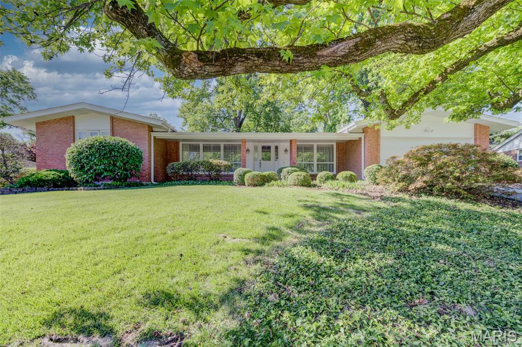 Come take a look. Original owners have given great love and care throughout the years, and this wonderful home is ready for another new beginning! Attractive curb appeal, exterior updates include newer roof, siding, fascia, and gutters. Newer front door has beveled glass and welcomes you into the foyer. The living room and dining room are on each side, with large, picture windows and lots of natural light. Just ahead is the heart of the home, the family room has a brick fireplace with ventless gas logs and sliding door to the patio and back yard. The kitchen has beautiful maple cabinets, tile backsplash, lots of counterspace, deep white sink and white appliances-dishwasher, cooktop, oven and refrigerator (which will remain with no warranty), ceramic flooring and newer windows. The primary bedroom has ensuite bath with newer vanity and shower. Nicely sized secondary bedrooms are convenient to the hall bath, with newer vanity and comfort height commode. There’s even a laundry chute! Freshly painted main level and newer, neutral carpeting have this home in move-in ready condition. And the seller is offering the HSA home warranty for buyer peace of mind. The lower level is an open canvas waiting for your finishing touches. HVAC has had twice yearly service, with a newer electrical panel installed in 2024. The oversized 2-car garage enters the kitchen and has service door to the back yard. Quick highway access, near Parkway schools, shopping, and Chesterfield Valley.
