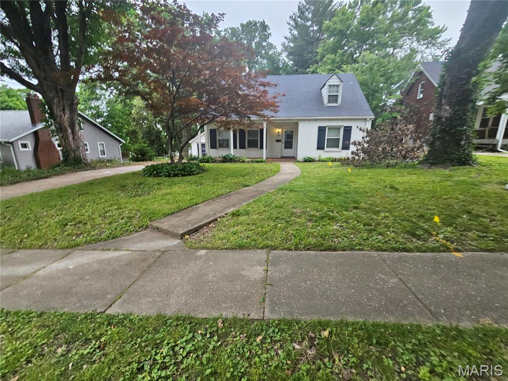 Charming 1.5-story brick home combines historic character with modern living. Step inside to find original hardwood floors, classic period trim, and a bright living room featuring a cozy woodburning fireplace. The main level offers a formal dining room, a functional kitchen, two spacious bedrooms, and a full bath. Upstairs, escape to a massive 600-sq-ft private master bedroom suite illuminated by beautiful skylights. The full walk-out basement boasts an 8ft+ pour and a partially finished family rec area. Outside, enjoy a level, fully fenced yard with a patio and a detached 1-car garage. Nestled in a historic Ferguson neighborhood.