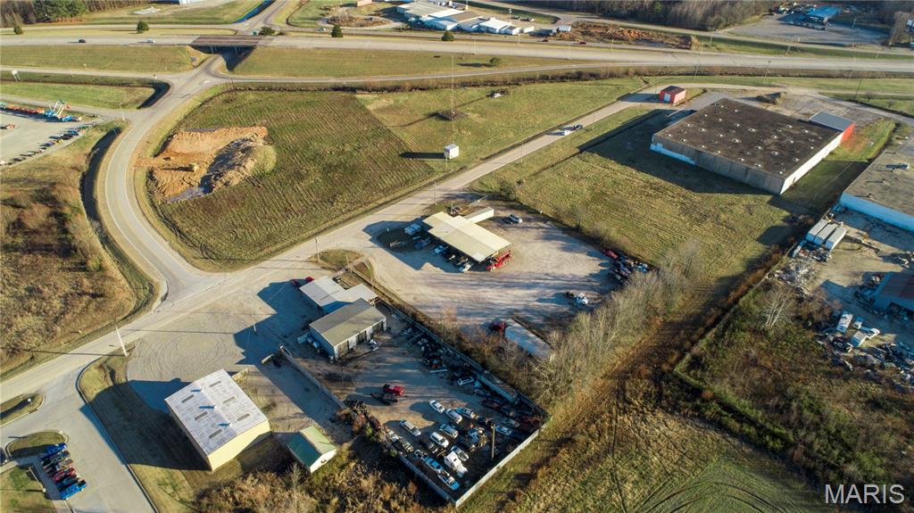Looking for turnkey commercial space, how about 2!  This one consists of trucking, towing, and mechanics dream business layout with 3 different red iron buildings built together over 4300 square foot with hanging lights, heaters, and winch spots.  Concrete floors and 6 roll up and through doors with big truck clearance.  There is also estimated 500 square foot office or retail with large office, front room, bathroom, and wash area with central electric heat and air.  Also to boot, attached lean-to lunch or party area private around the shop for cookouts or outside work.  This business sits of .88 acres.
Then comes the 2nd building.  The office area has been recently renovated, just needs paint and your business touch.  There is large entry room one private office and bath in this heated and cooled estimated 400 square foot. Connected to warehouse and storage building just holding toys with high ceilings and another red iron building,  Total square foot on this building is 3100 square foot with 8 large rolling doors to loading docks mostly all with covered entrances.  Large open gravel lot for big truck turn around and additional 50 Amp connects in the back of 2.12 acres, totaling both property sided by side with separate security and privacy fence on 3 acres.