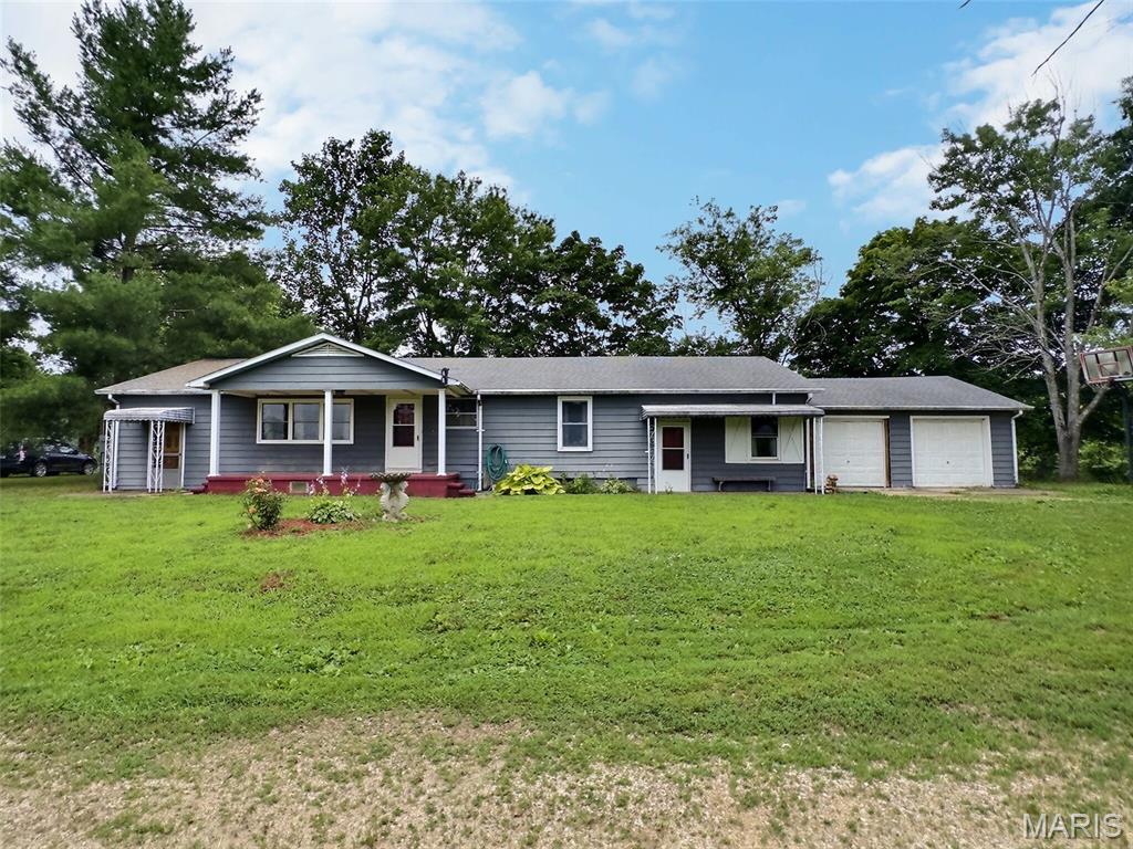 Escape to the peace and privacy of rural Bollinger County with this spacious 4-bedroom, 1.5-bath home situated on over 2 acres just north of Advance, Missouri. Built in 1970 and offering approximately 1,980 square feet of living space, this property combines comfortable country living with plenty of room to spread out. Inside, you'll find a large kitchen with abundant space for meal preparation and gathering, a separate dining room for family dinners and entertaining, and a comfortable living room. The oversized fourth bedroom measures more than 28' x 15' and offers exceptional flexibility—it could easily serve as a sunken family room, recreation room, home office, or guest space. Outside, the beautiful yard features expansive open areas and several mature shade trees, creating a picturesque setting for outdoor enjoyment. Additional features include a small older storage shed, private well and septic system, a two-car garage, and extra parking space for guests, recreational vehicles, or equipment. Located approximately 5 miles north of Advance near Dongola Baptist Church, this property offers the tranquility of a rural setting while remaining conveniently accessible. If you've been looking for country living with acreage, space, and versatility, this home is one you won't want to miss.