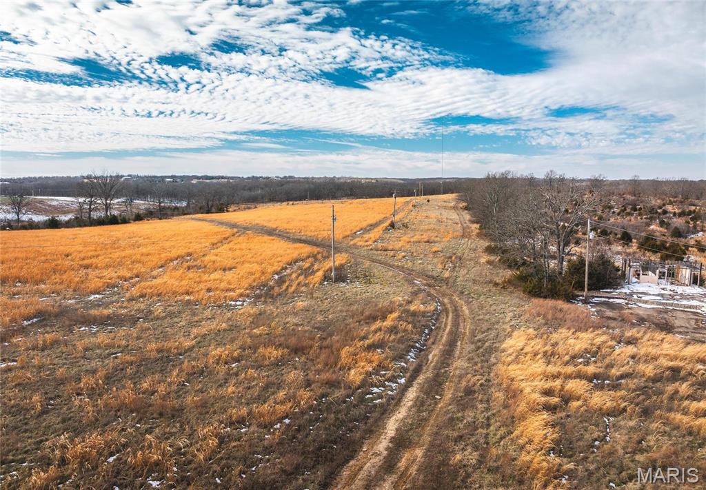 Seven Miles, only Seven miles to the Lake of the Ozarks lies a large tract of land of 129+/- acres. It has a old infrastructure of a RV campground that was before its time, if someone wants a nice recreational property or the large piece for the family to have for home, horses, cattle or just to hunt and ride your off road vehicles this is the place. BUT Now is the Opportunity for the investor to capitalize on having a new neighboring Elite Baseball & Softball Complex, BALLPARK NATIONAL in Macks Creek. The complex is a great up and coming place for amateur baseball and softball teams to play tournaments but there really is no lodging for those coming down to play. So if you want to create a place of lodging and or newer campground only being a short distance to the lake access HERE IT IS !!!!!!!!!

Well and septic are old not sure if either are in working order