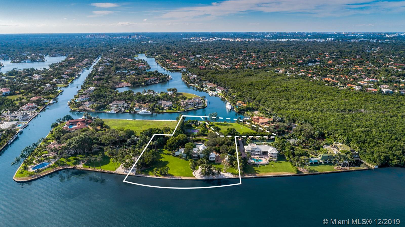 A once in a lifetime opportunity to purchase the largest parcel of land situated within the secure gates of Gables Estates.  The properties consist of 4.5 acres with 630 feet of combined water frontage over 2 lots.  The main residence is a 3.3 acre property with 450’ of direct bay frontage.  Enjoy expansive views of the bay out to Key Biscayne, South Beach and the Downtown Miami Skyline. Directly across the private street, sits an additional 1 acre waterfront lot, with 180’ of seawall - the perfect set up for yachters. This lot includes a tennis court, 2 boat lifts, and plenty of storage for water toys.  An additional 1.25  acre abutting waterfront vacant lot can be purchased with the sale for over 5.5 total acres — making this the largest privately owned property in all of Gables Estates.